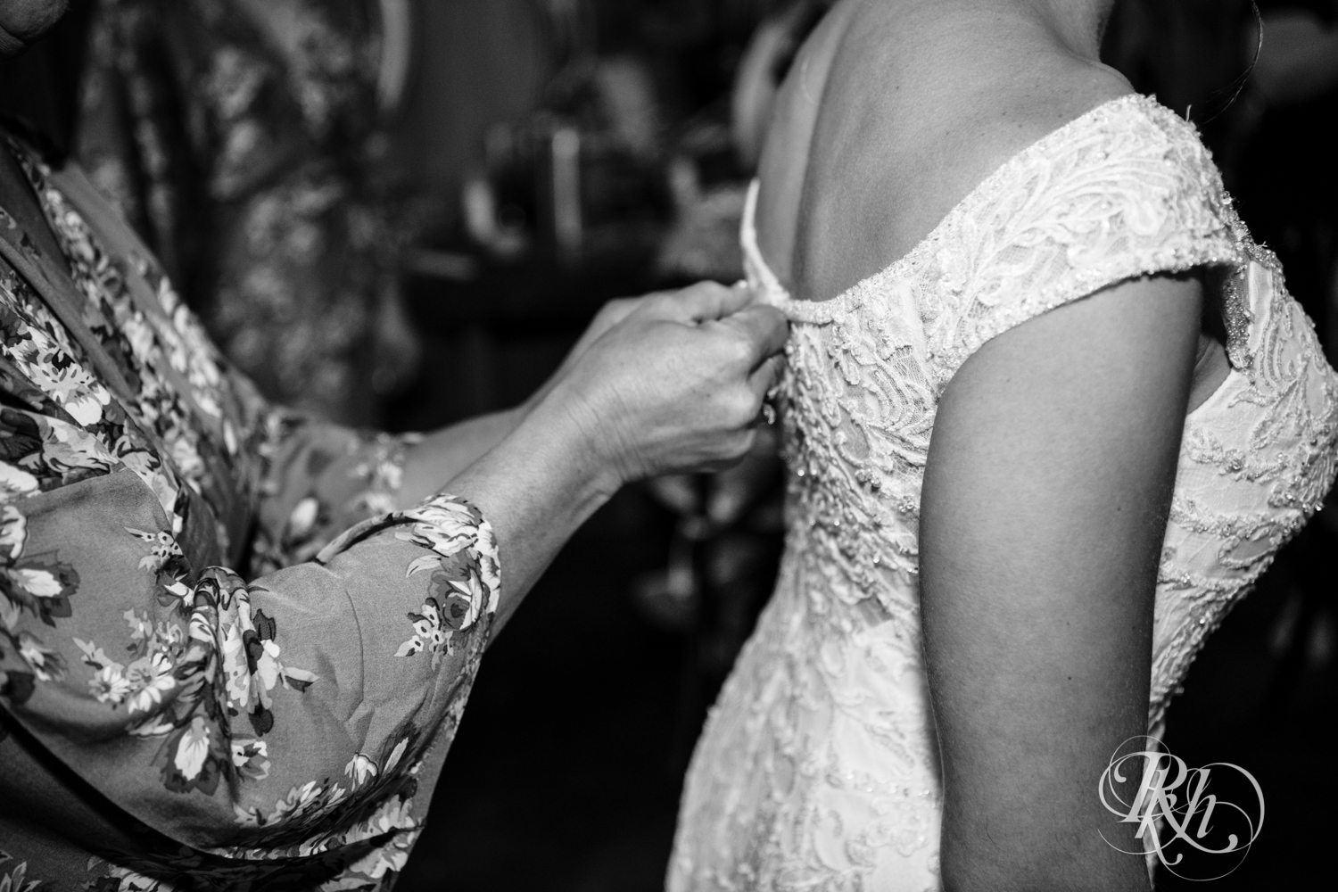 Grandma zipping bride into dress at Creekside Farm Weddings and Events in Rush City, Minnesota.