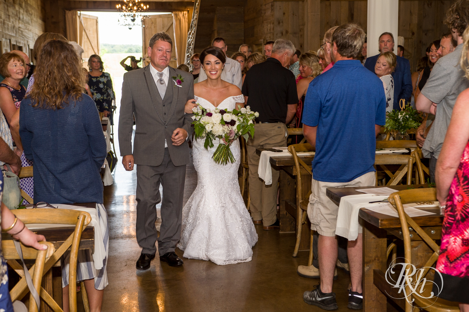 Bride and her dad walk down the aisle at Creekside Farm Weddings and Events in Rush City, Minnesota.