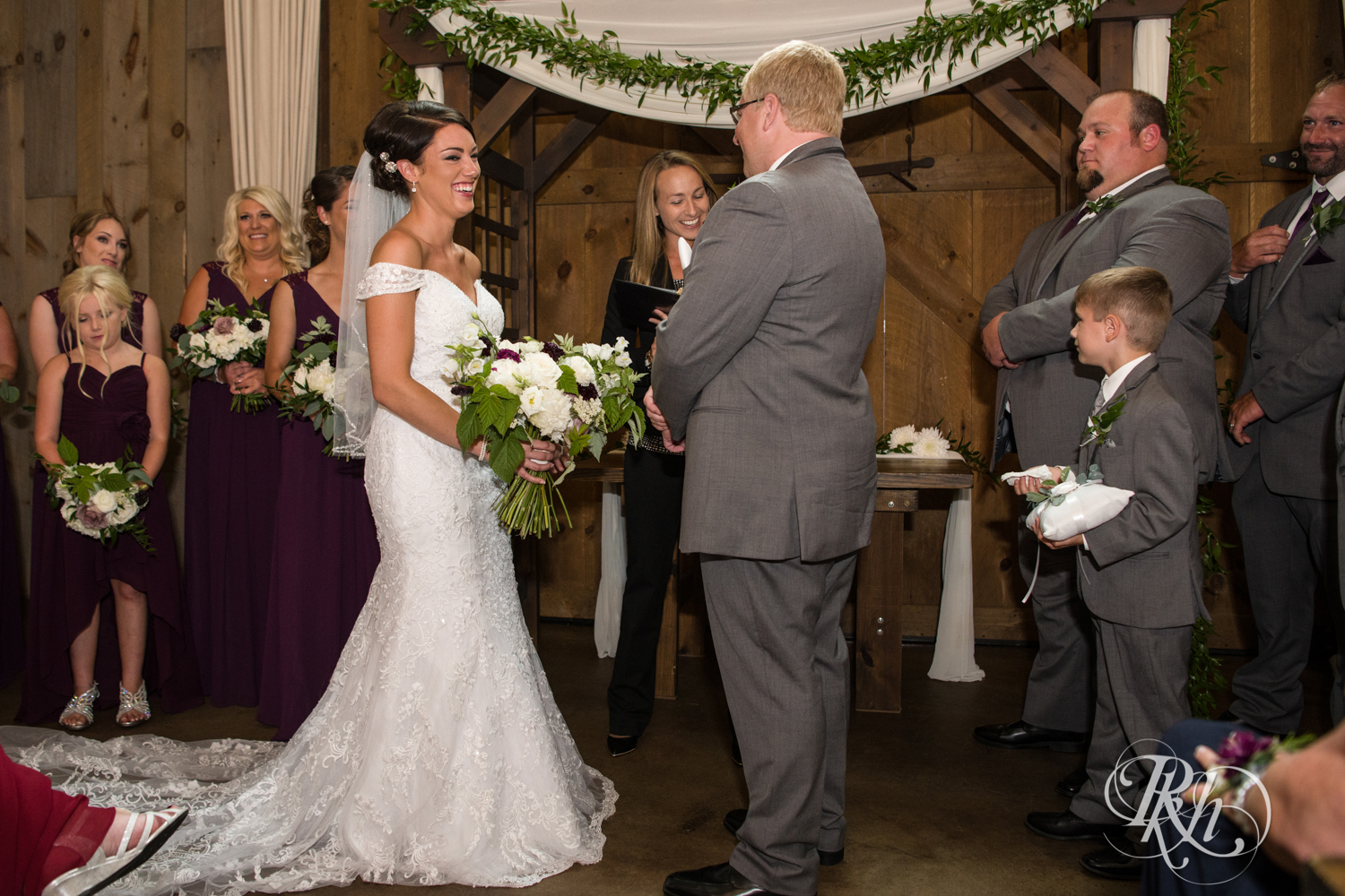 Bride and groom laugh during ceremony at Creekside Farm Weddings and Events in Rush City, Minnesota.