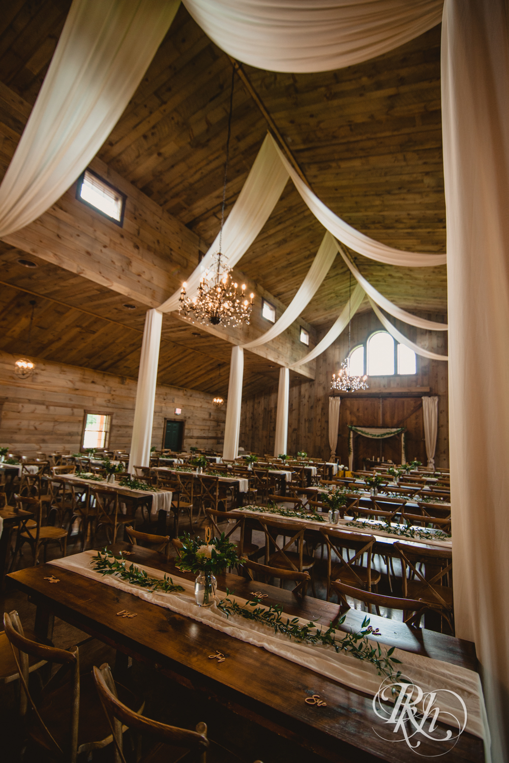 Indoor barn wedding reception setup at Creekside Farm Weddings and Events in Rush City, Minnesota.
