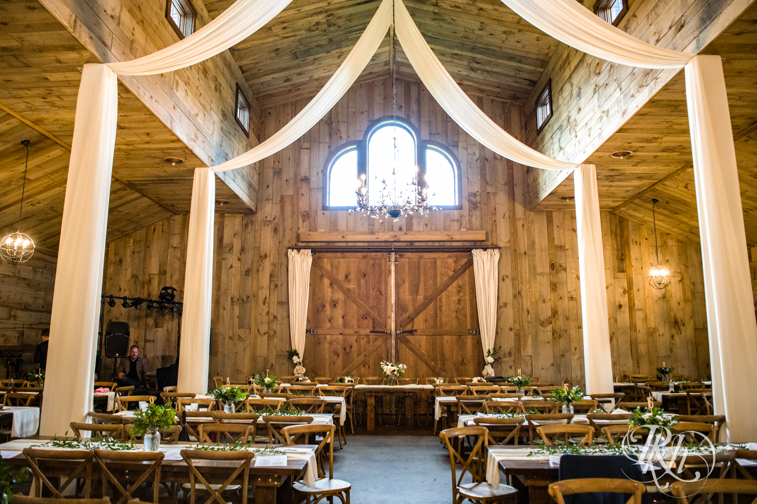 Indoor barn wedding reception setup at Creekside Farm Weddings and Events in Rush City, Minnesota.