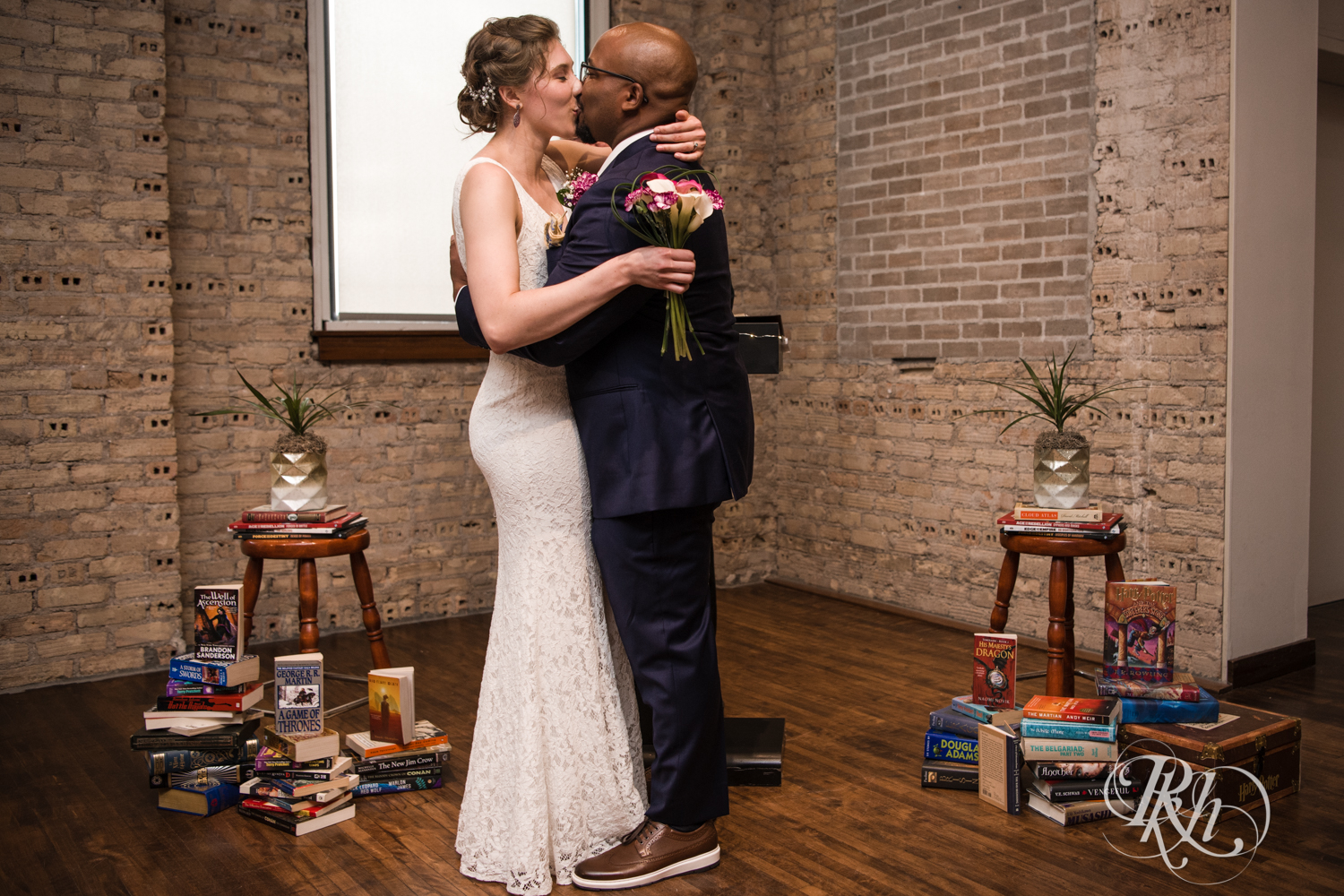 Biracial bride and groom kissing during wedding at Five Event Center in Minneapolis, Minnesota.