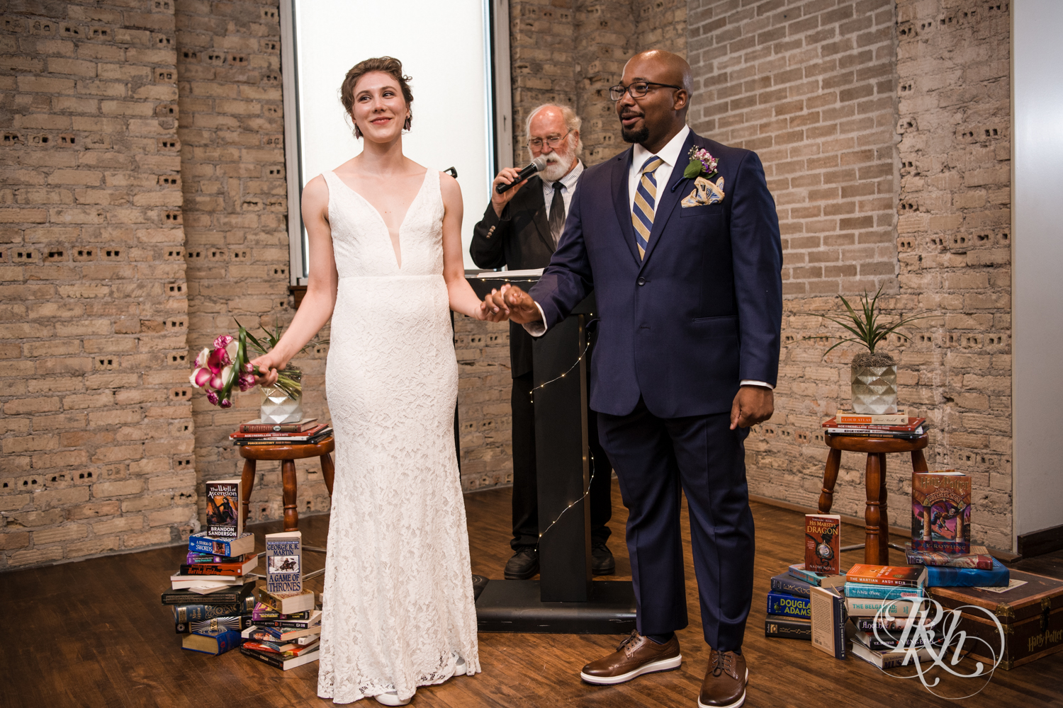 Biracial bride and groom laughing during wedding at Five Event Center in Minneapolis, Minnesota.