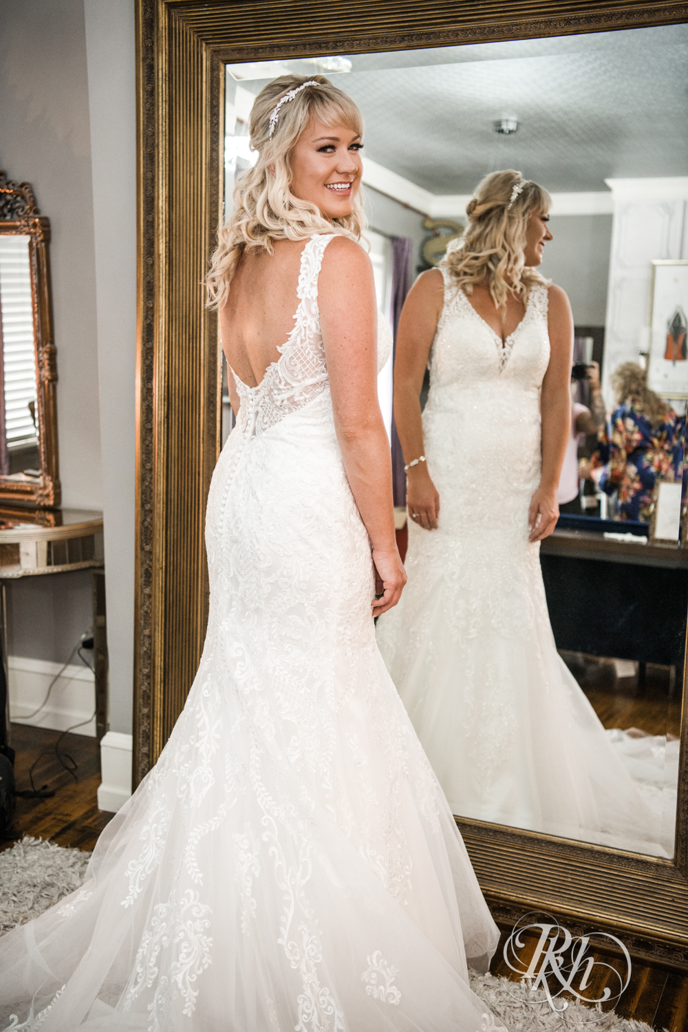 Bride standing in front of mirror before wedding at the Semple Mansion in Minneapolis, Minnesota.