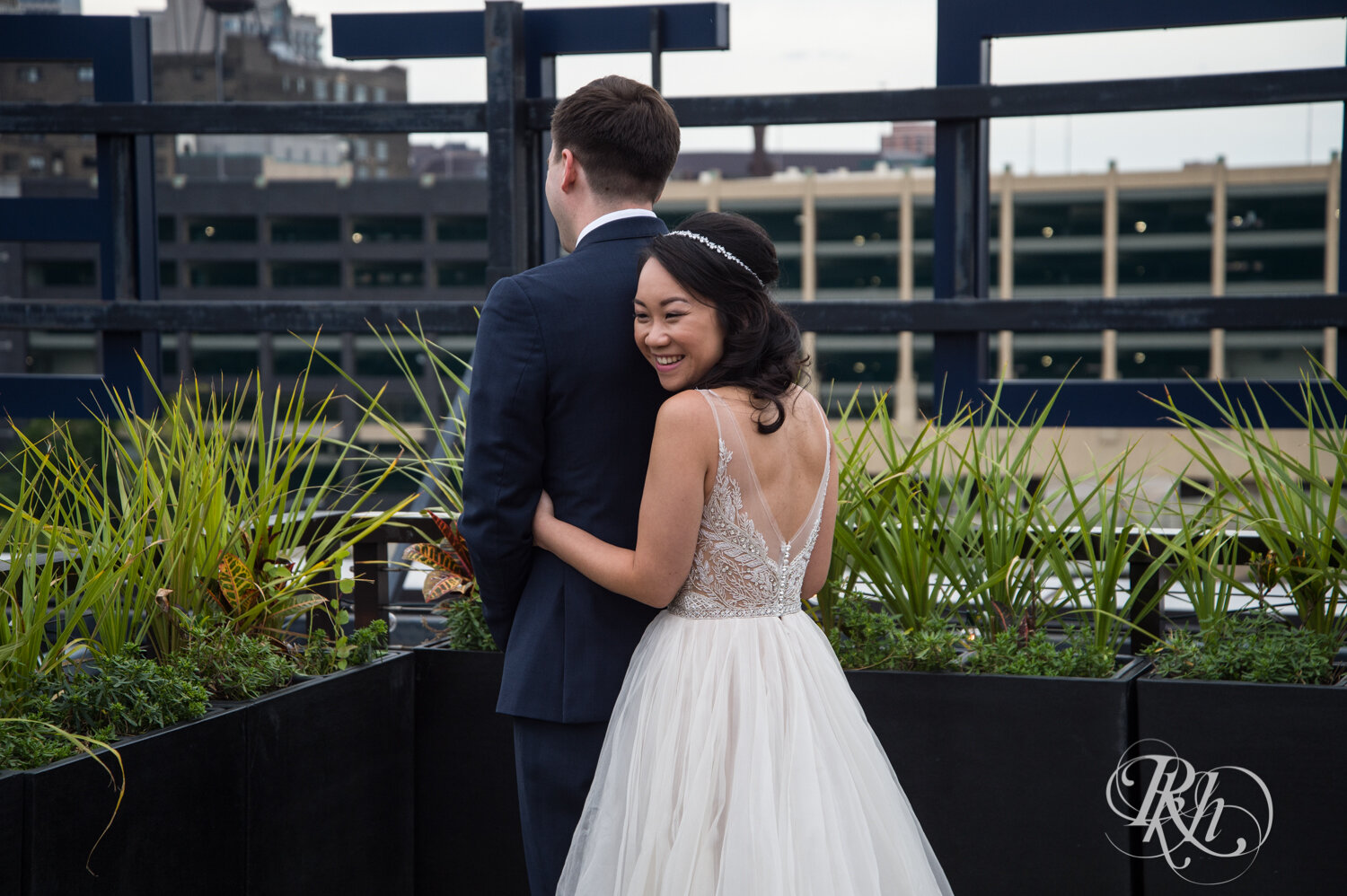 Asian bride and groom share first look on rooftop of the Hewing Hotel in Minneapolis, Minnesota.