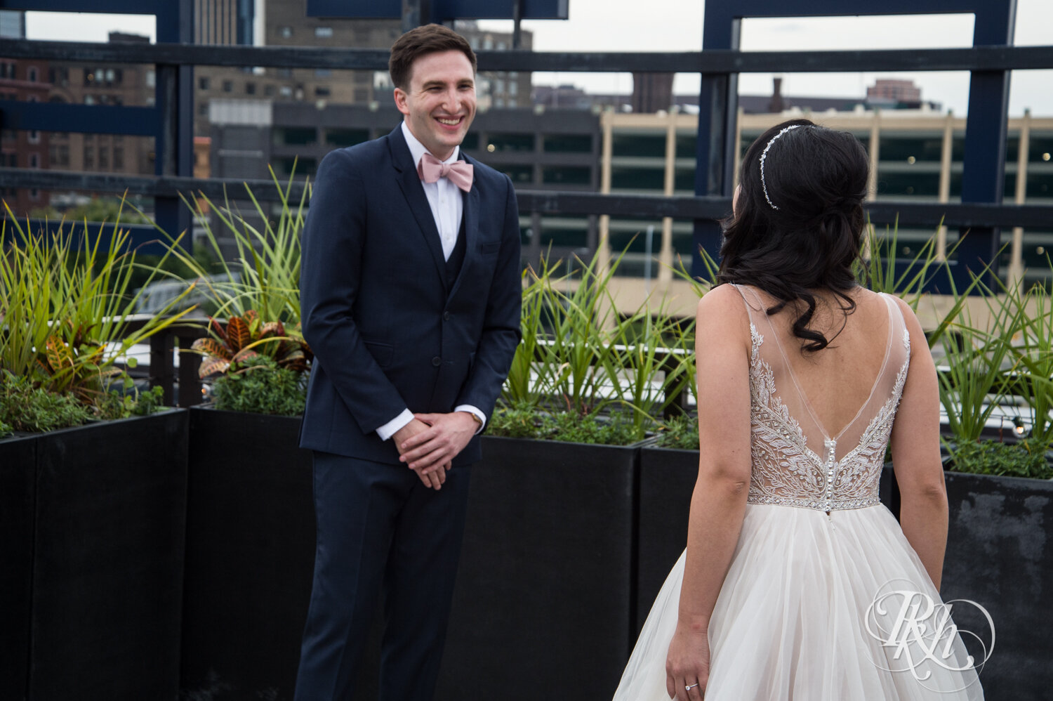 Asian bride and groom share first look on rooftop of the Hewing Hotel in Minneapolis, Minnesota.