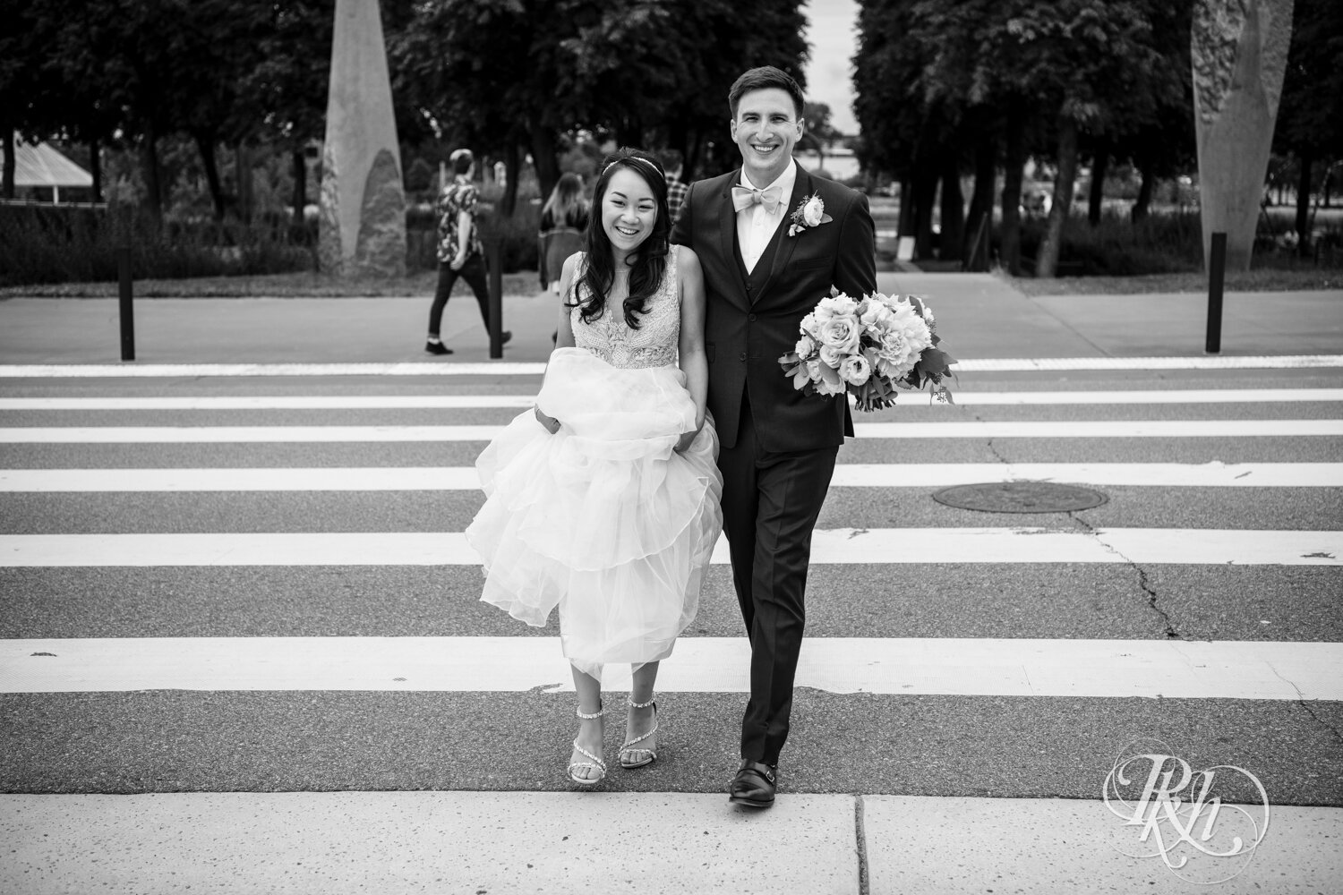 Bride and groom crossing street