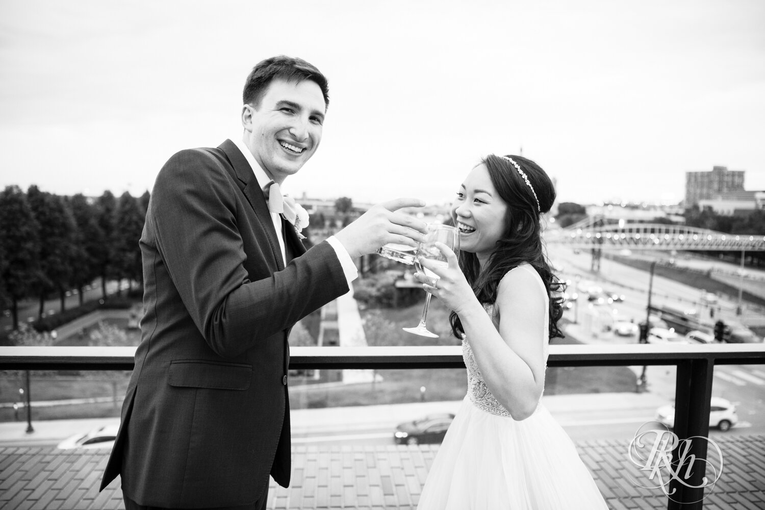 Bride and groom toast during cocktail hour on rooftop of Walker Art Center in Minneapolis, Minnesota. 