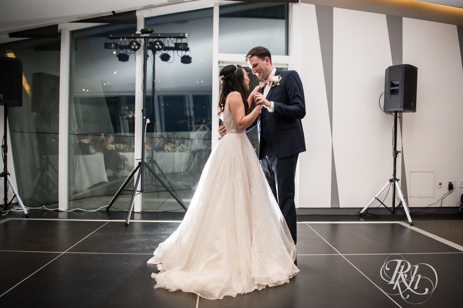 Asian bride and groom dance during wedding reception at Walker Art Center in Minneapolis, Minnesota. 
