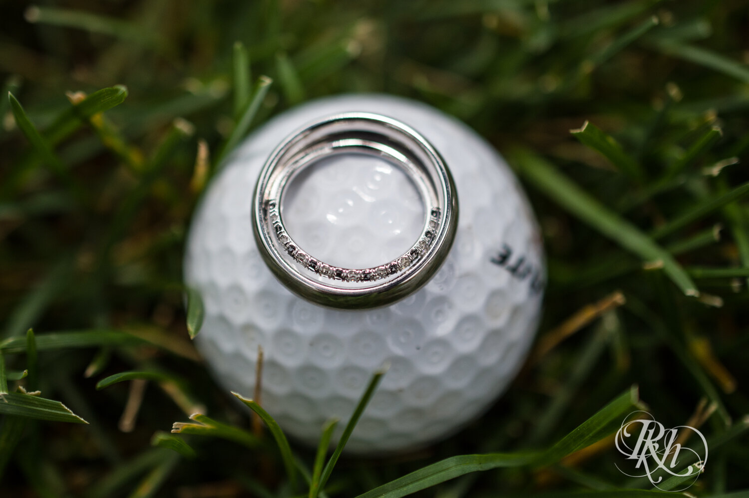Wedding rings on golf ball at Olympic Hills Golf Club in Eden Prairie, Minnesota.