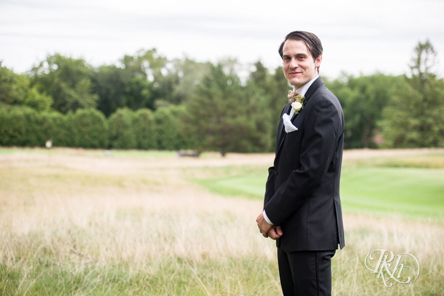 Bride and groom share first look at Olympic Hills Golf Club in Eden Prairie, Minnesota.