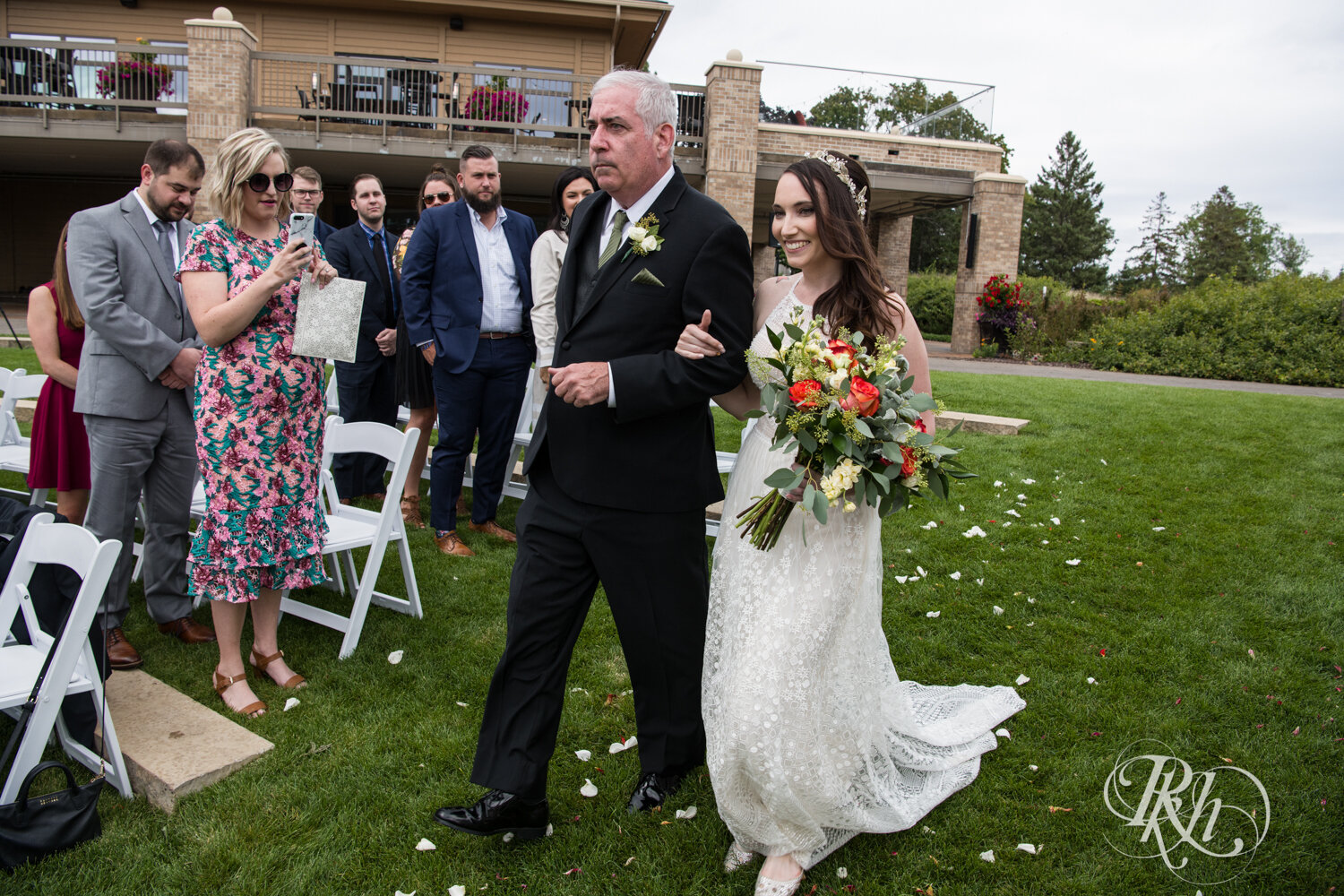 Bride walks down the aisle with her dad at Olympic Hills Golf Club in Eden Prairie, Minnesota.