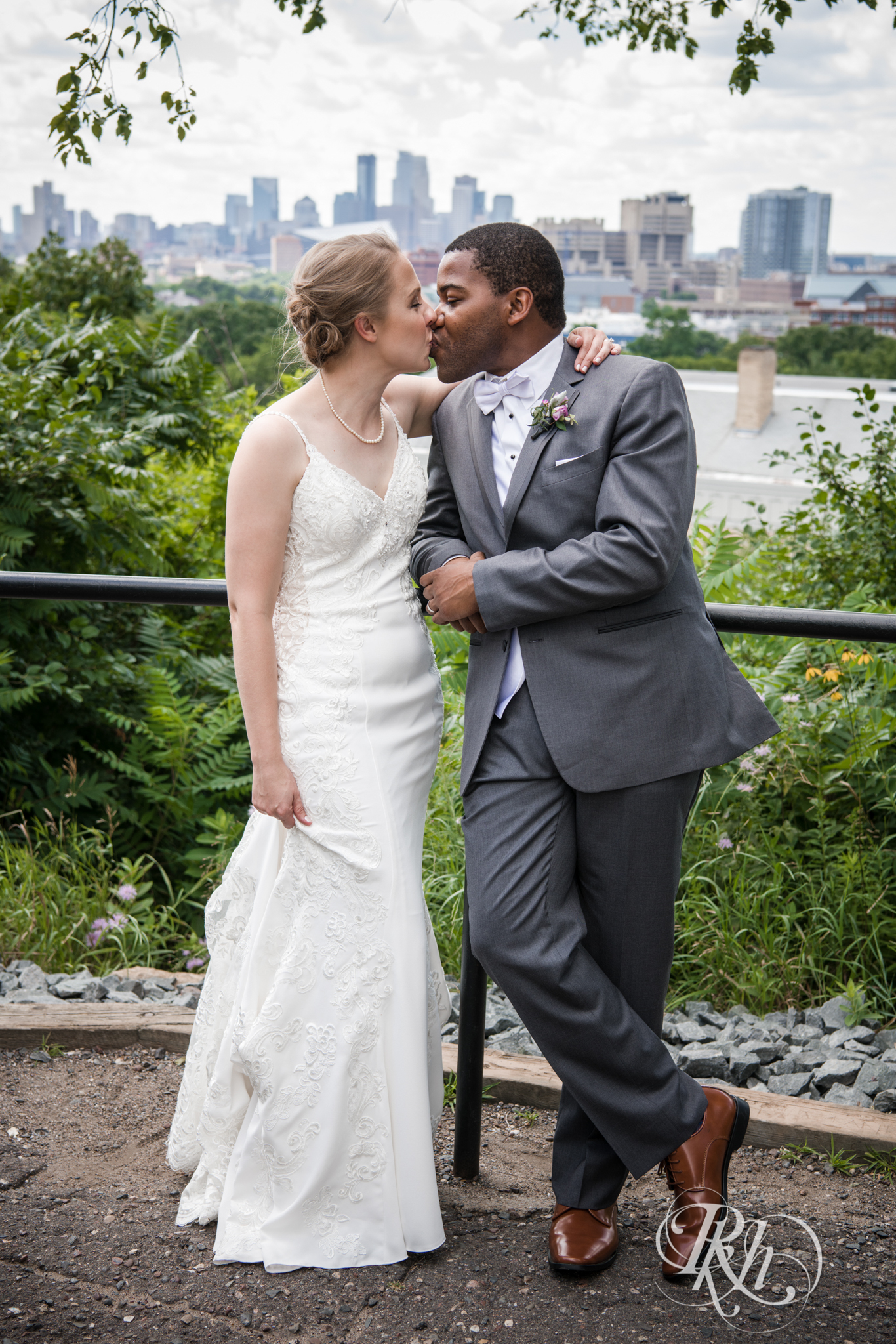 biracial bride and groom kissing