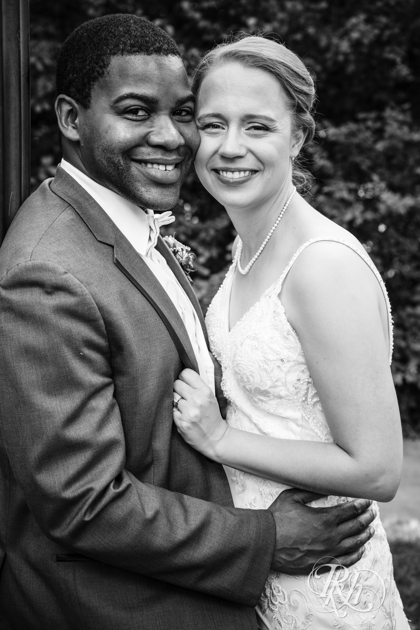 Black groom and white bride smile at Witches Hat in Saint Paul, Minnesota.