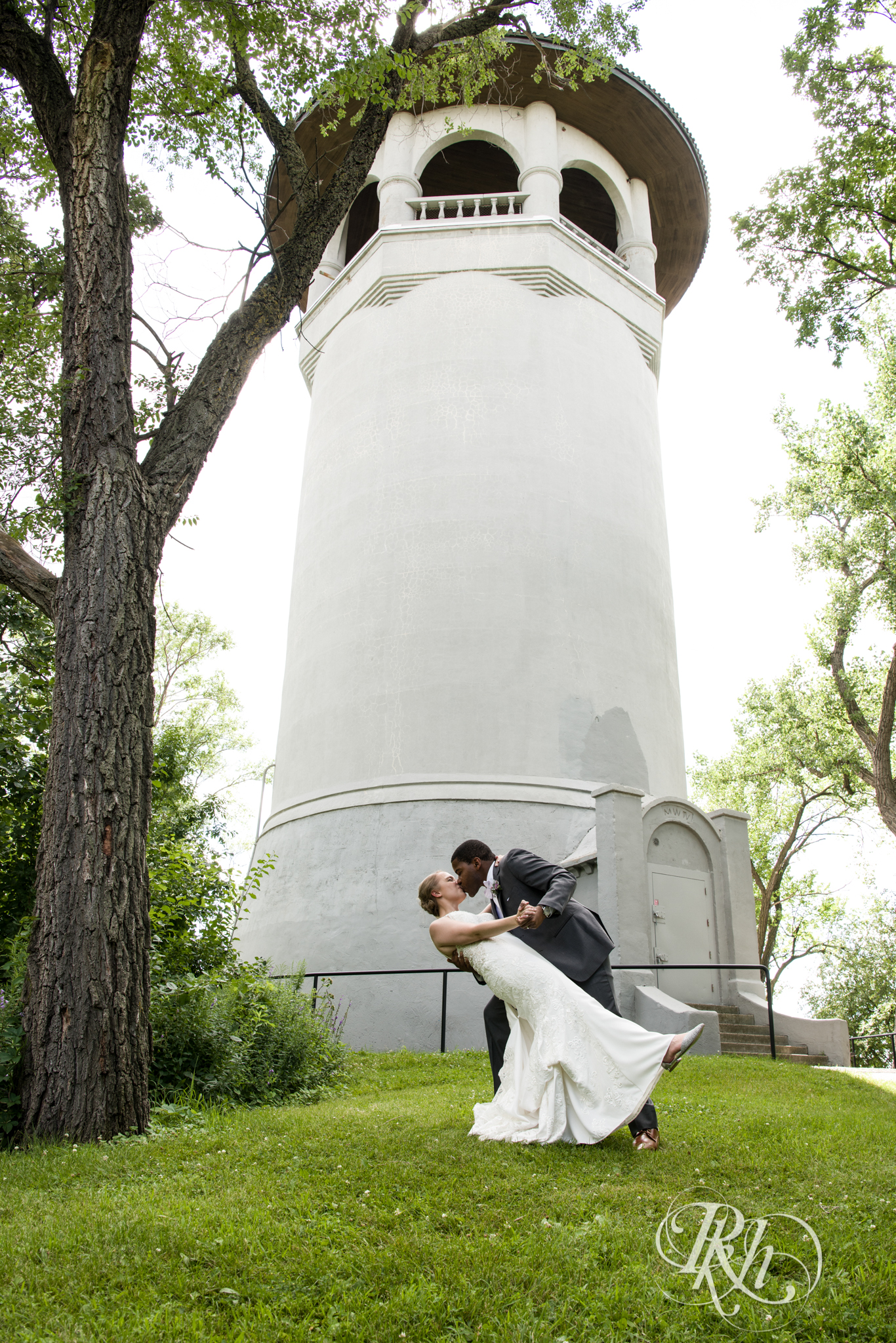 Black groom and white bride kiss at Witches Hat in Saint Paul, Minnesota.