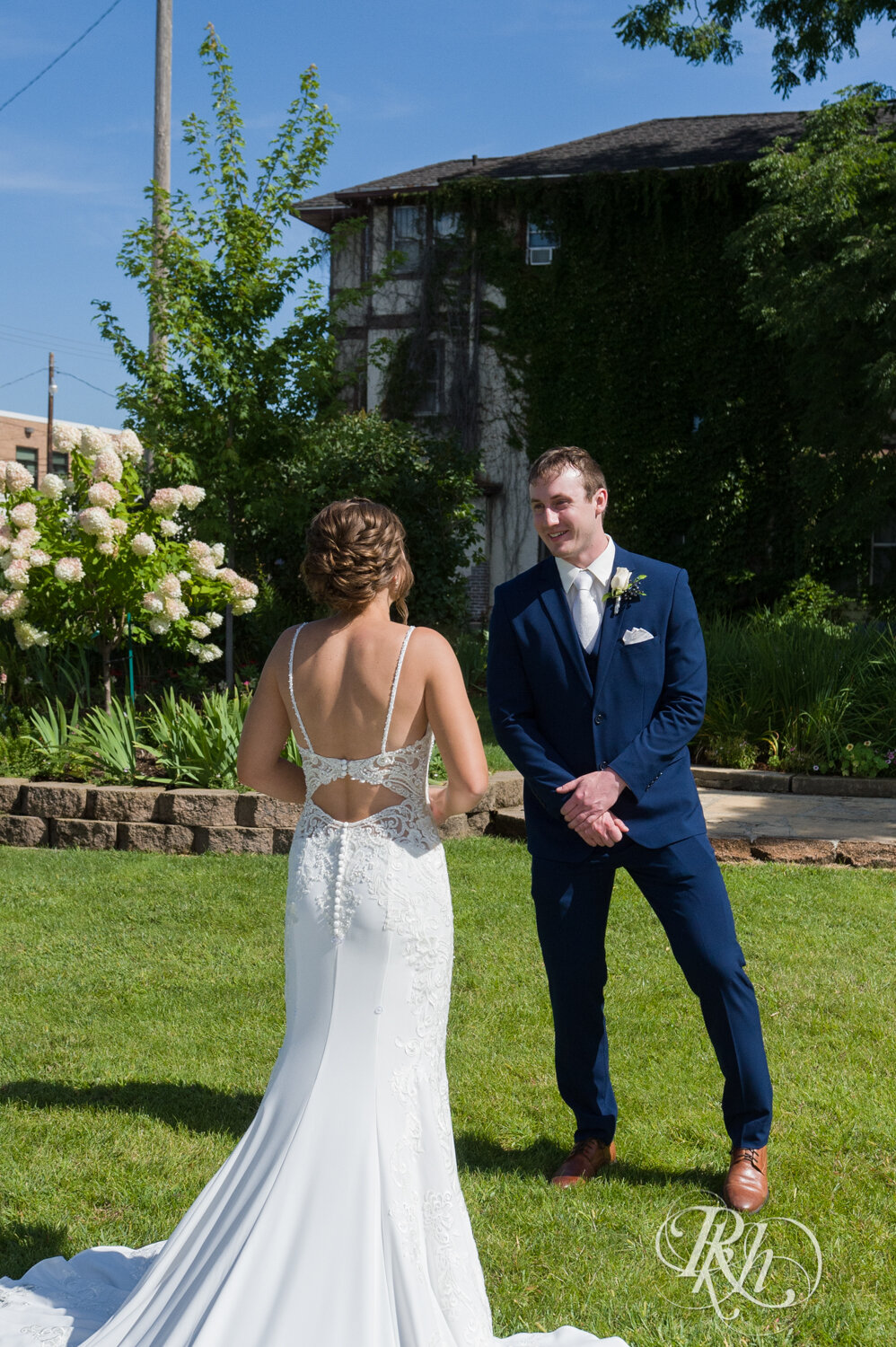 Bride and groom share first look on sunny day in Mankato, Minnesota.