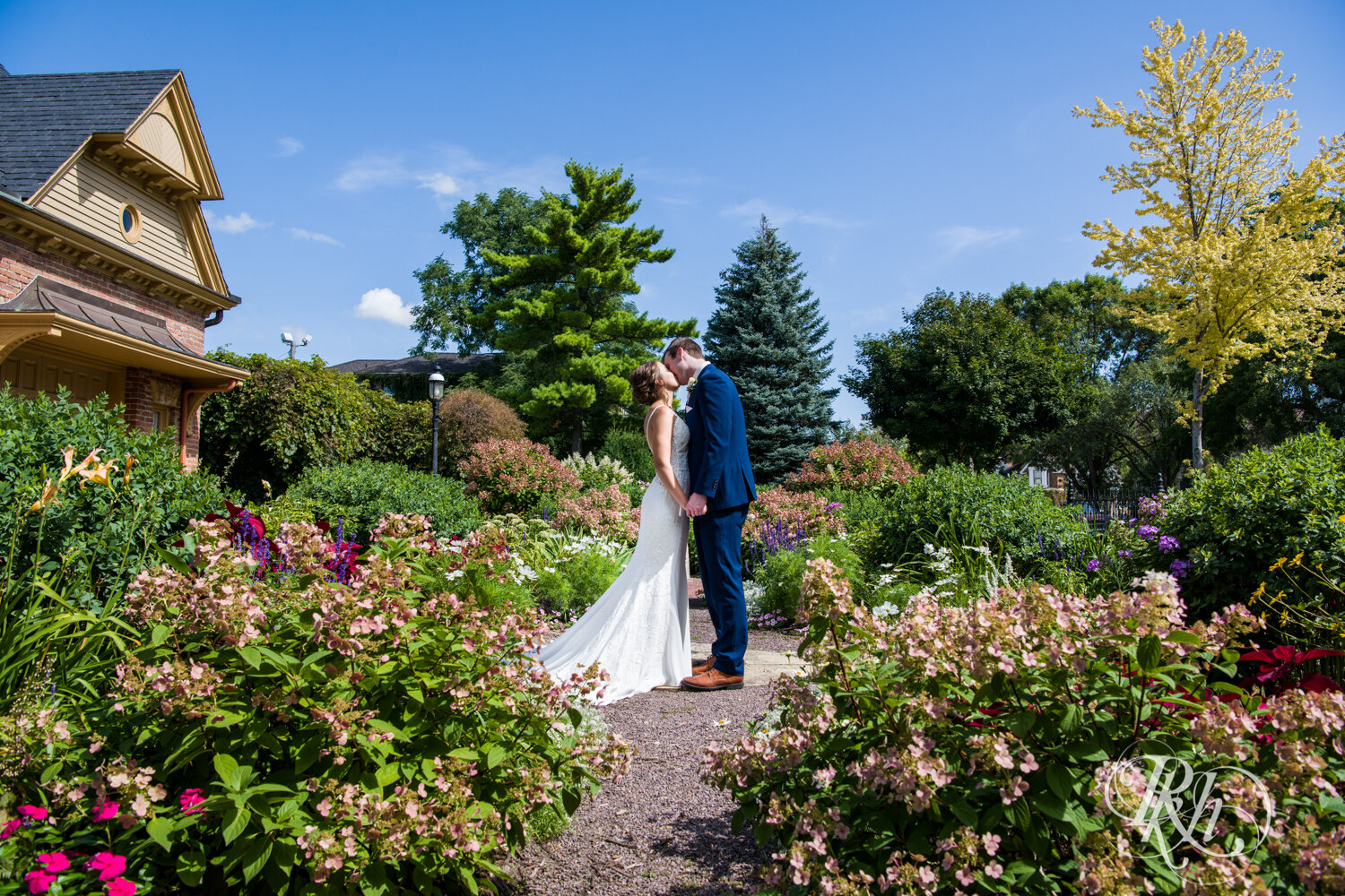 Bride and groom kiss on sunny day in Mankato, Minnesota.