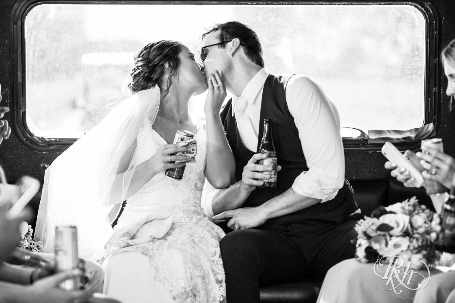 Bride and groom kiss in the back of the party bus in Mankato, Minnesota.