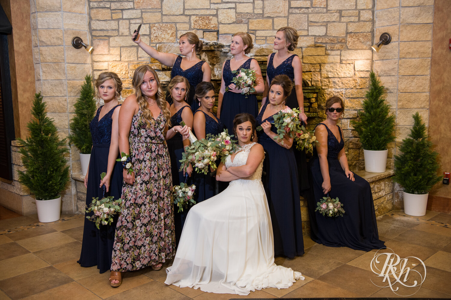 Wedding party in blue dresses smile at Crown Room in Rogers, Minnesota.
