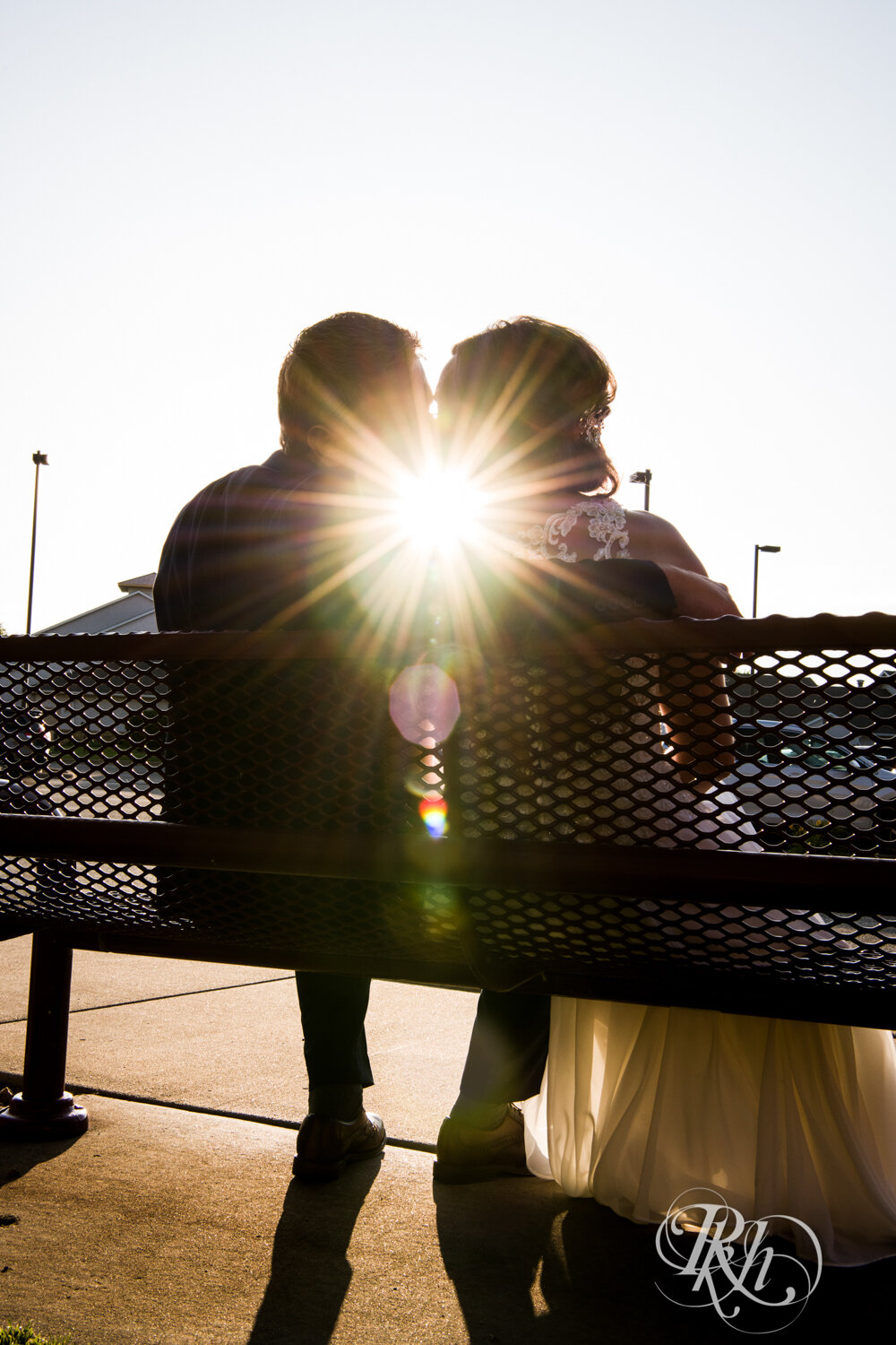 Bride and groom kiss at sunset at Crown Room in Rogers, Minnesota.