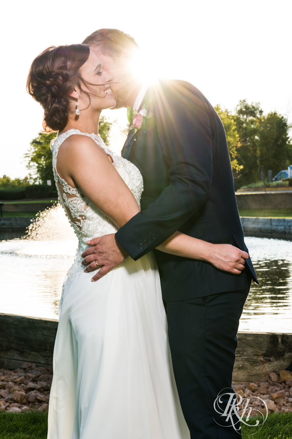 Bride and groom kiss at sunset at Crown Room in Rogers, Minnesota.