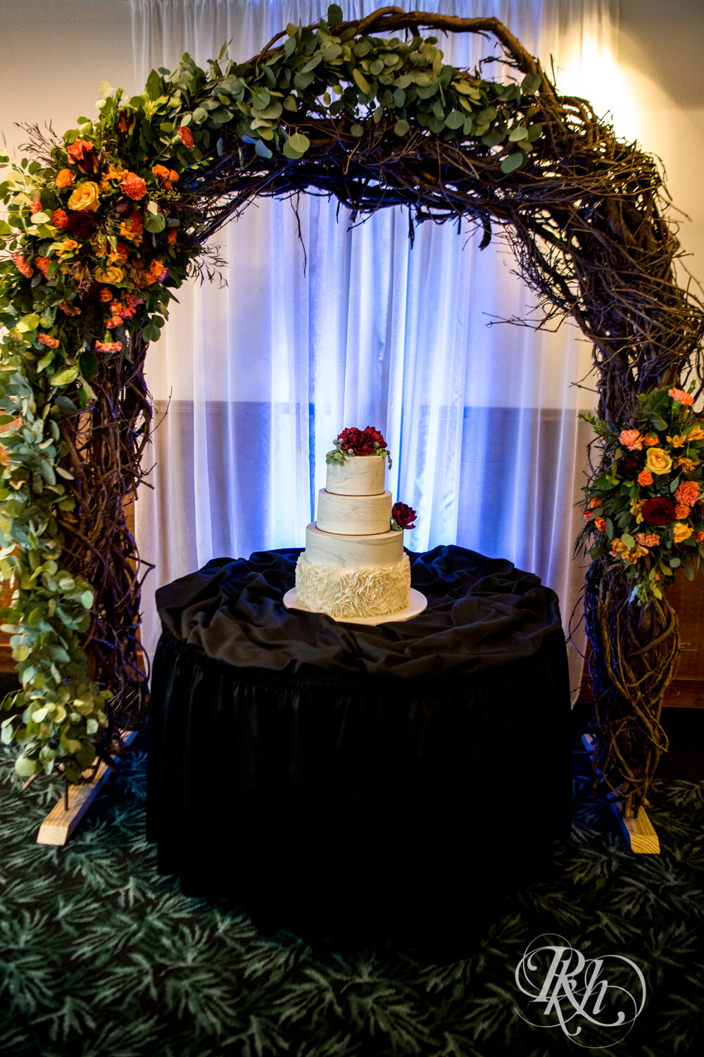 Wedding cake with fall wedding arbor at Rockwoods in Otsego, Minnesota.
