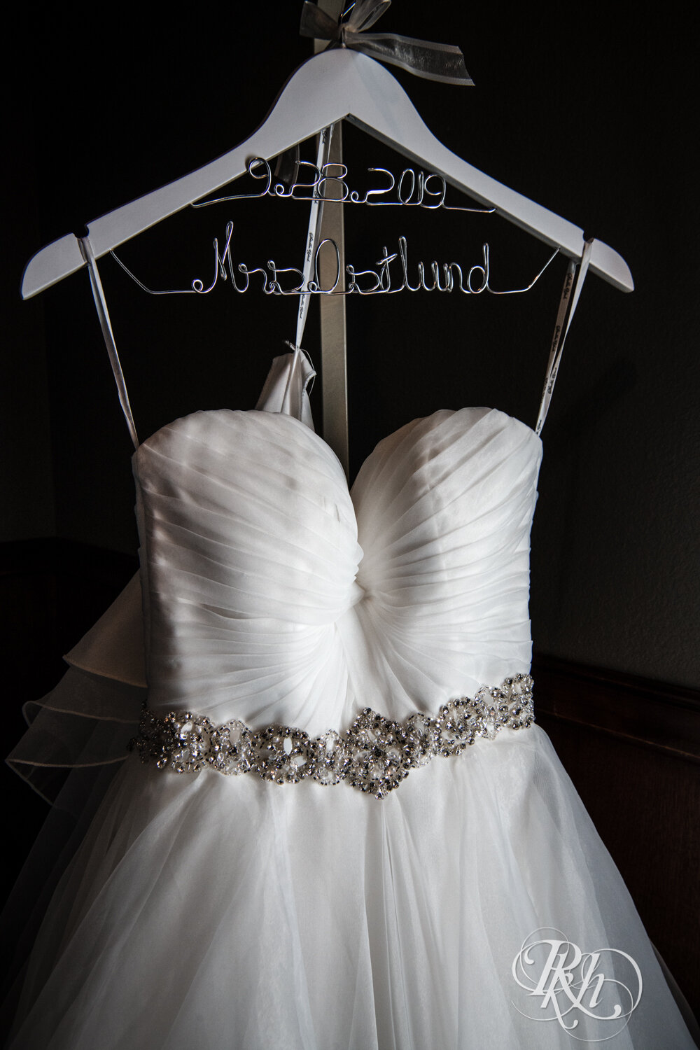 Wedding dress on hanger with date and last name at Rockwoods in Otsego, Minnesota.
