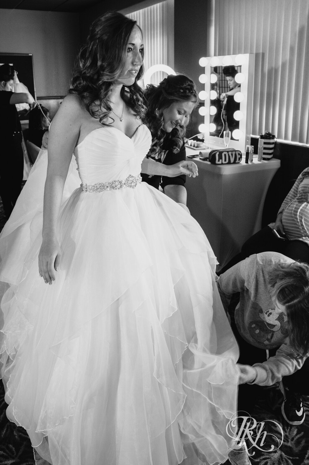 Bride getting wedding dress zipped up at Rockwoods in Otsego, Minnesota.