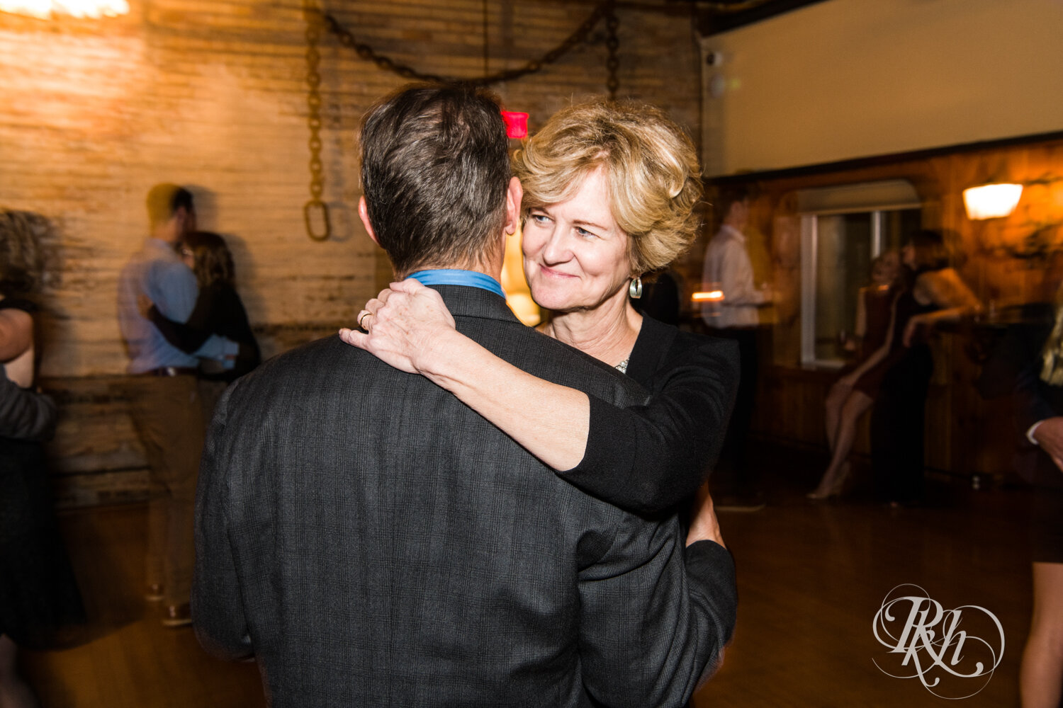 Bride and groom dance with guests at wedding reception at Kellerman's Event Center in White Bear Lake, Minnesota.