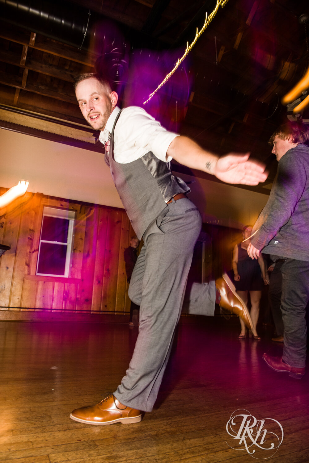 Bride and groom dance with guests at wedding reception at Kellerman's Event Center in White Bear Lake, Minnesota.