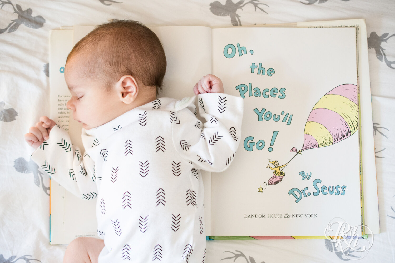 Baby lying on Dr. Seuss book