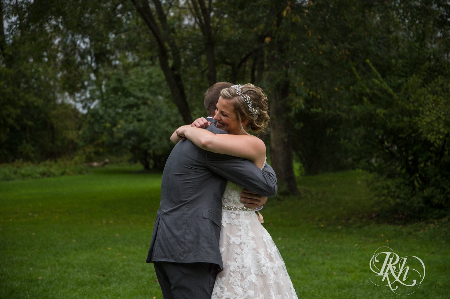 Bride and groom share first look at Camrose Hill Flower Farm in the rain in Stillwater, Minnesota.