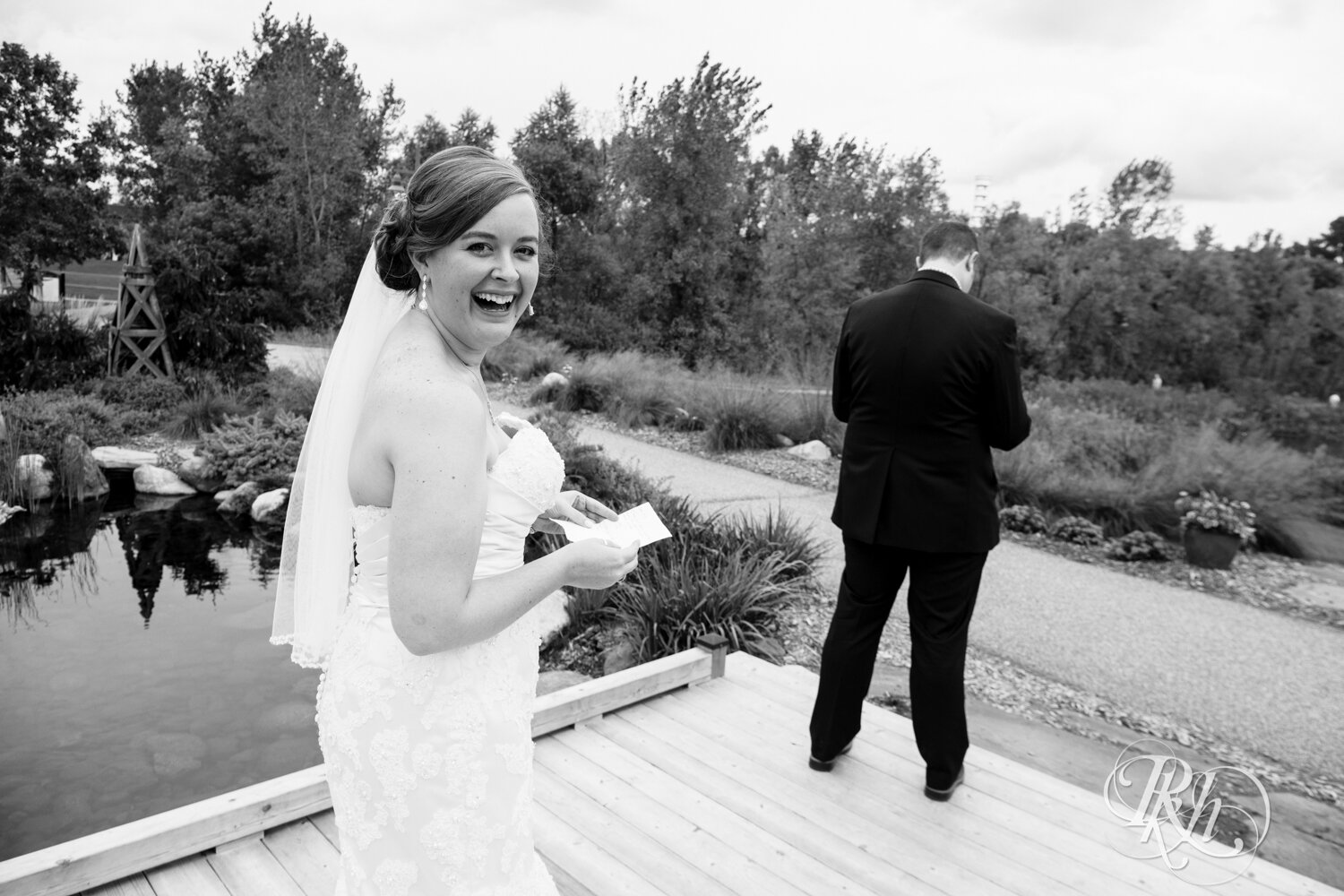 Bride and groom share first look on bridge at Eagan Community Center in Eagan, Minnesota.