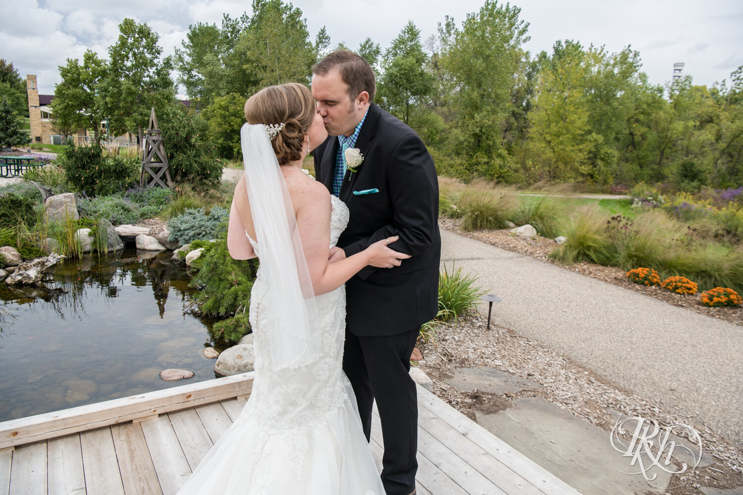Bride and groom share first look on bridge at Eagan Community Center in Eagan, Minnesota.