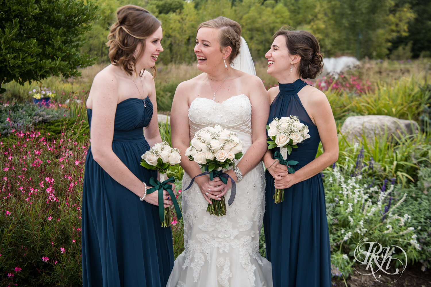 Wedding party in blue dresses laugh at Eagan Community Center in Eagan, Minnesota.