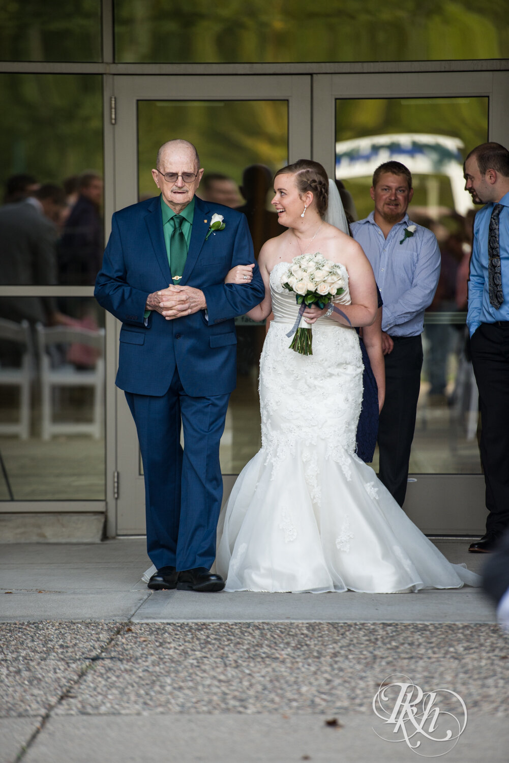 Bride walks down the aisle with grandpa at Eagan Community Center in Eagan, Minnesota.