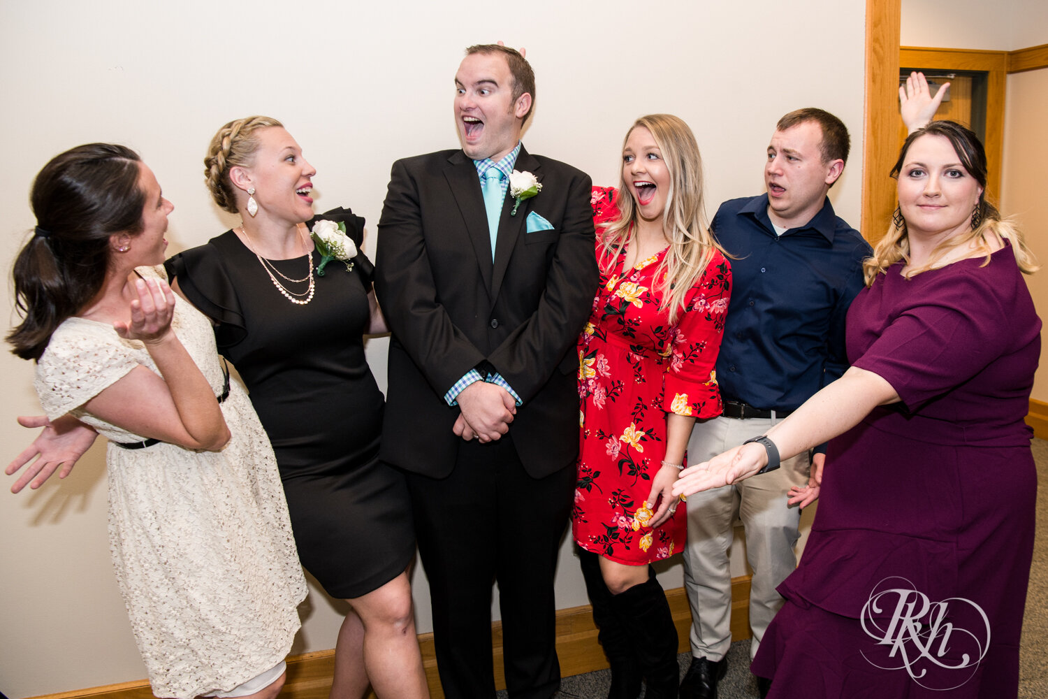 Guests laugh with groom at wedding reception at Eagan Community Center in Eagan, Minnesota.