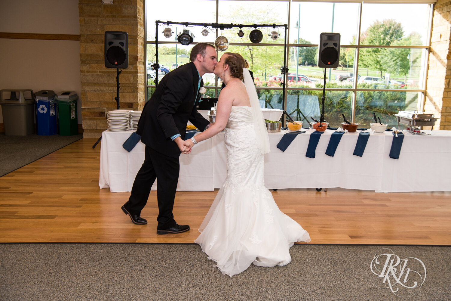 Bride and groom kiss during wedding reception at Eagan Community Center in Eagan, Minnesota.
