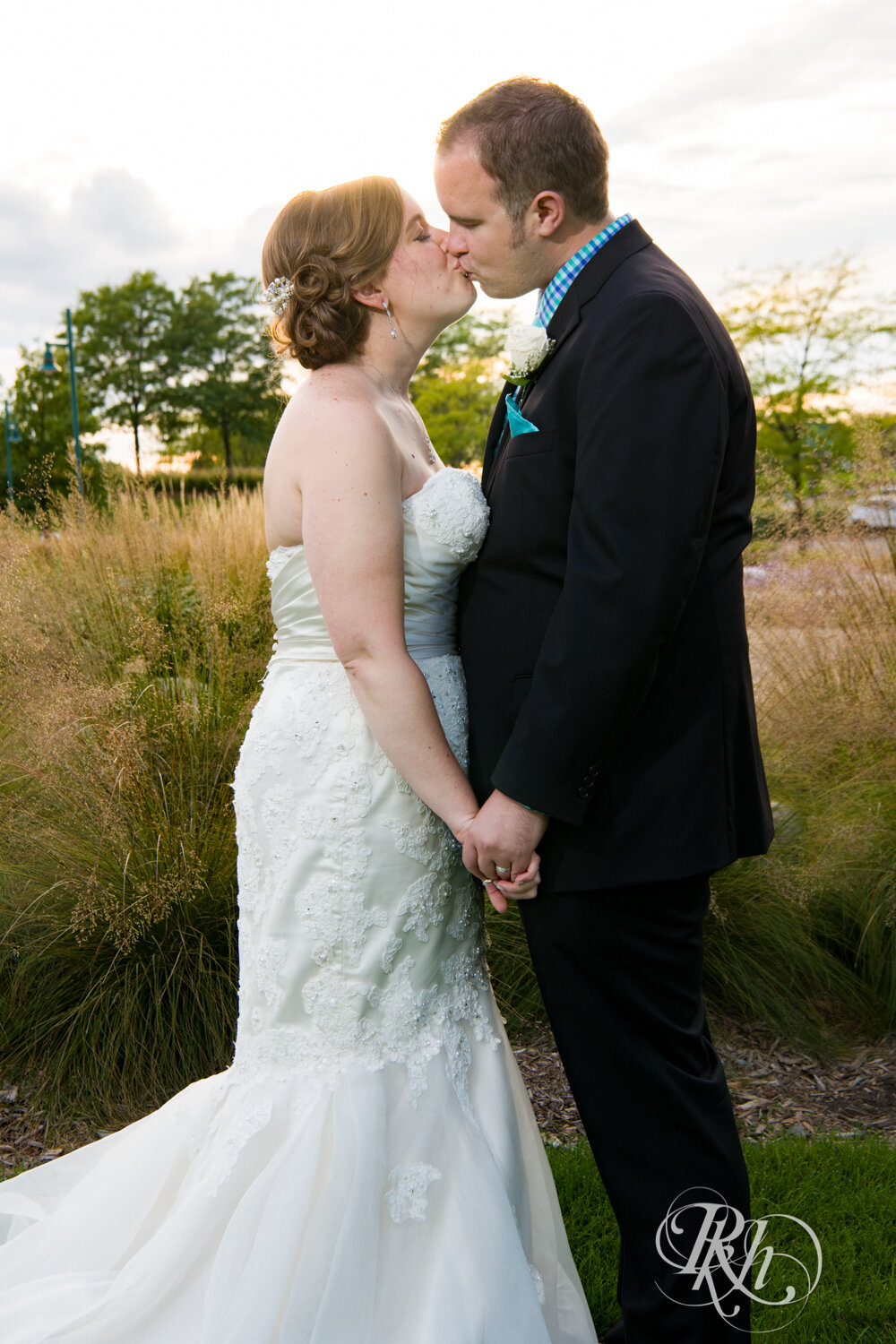 Bride and groom kiss during sunset at Eagan Community Center in Eagan, Minnesota.