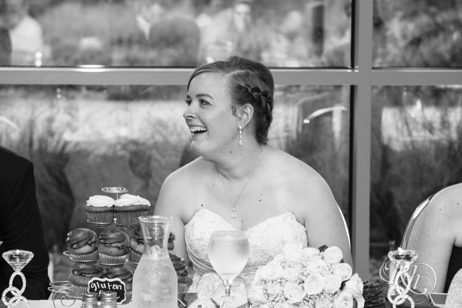 Bridesmaid laughs during speech at wedding reception at Eagan Community Center in Eagan, Minnesota.
