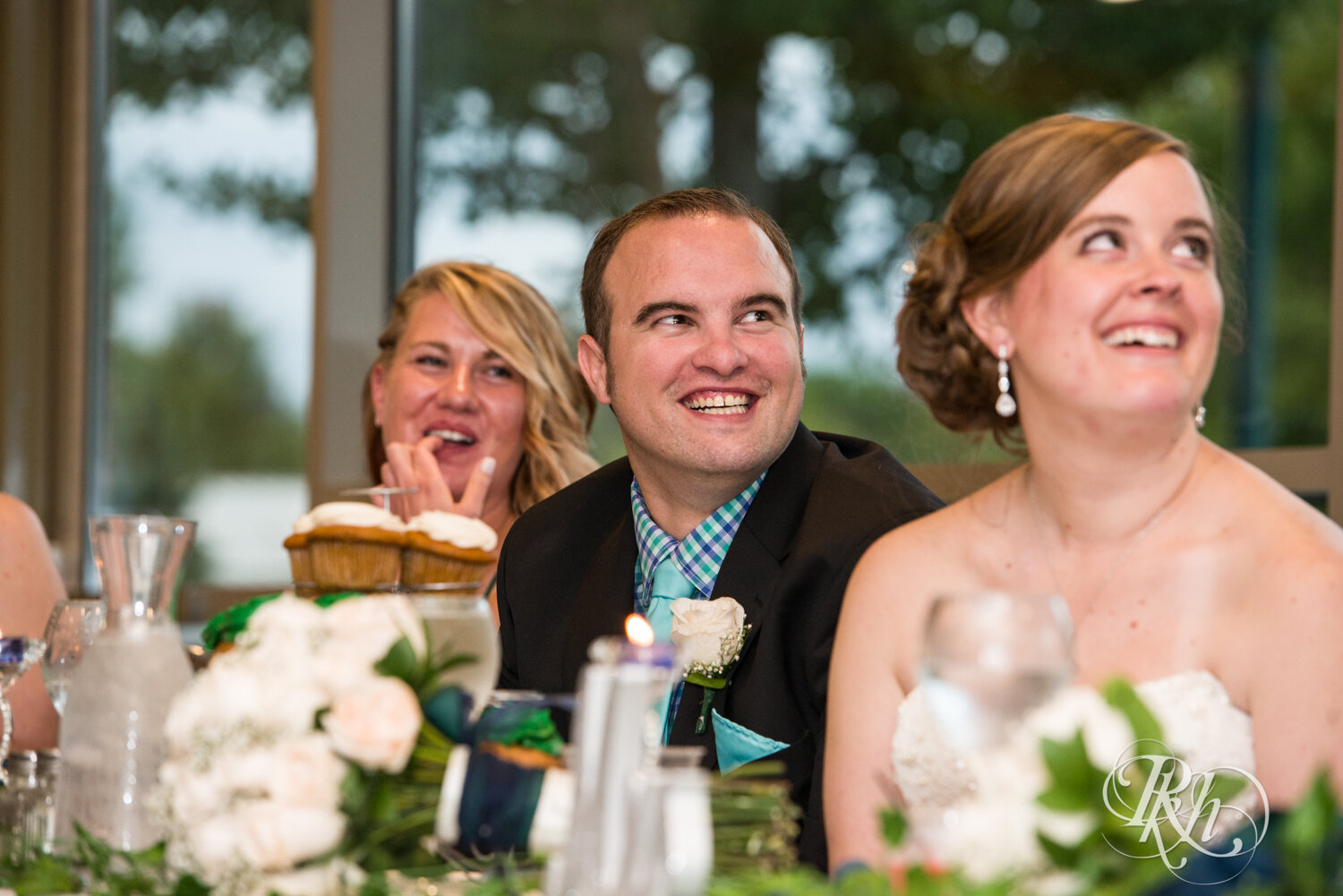 Groom laughs during speech at wedding reception at Eagan Community Center in Eagan, Minnesota.