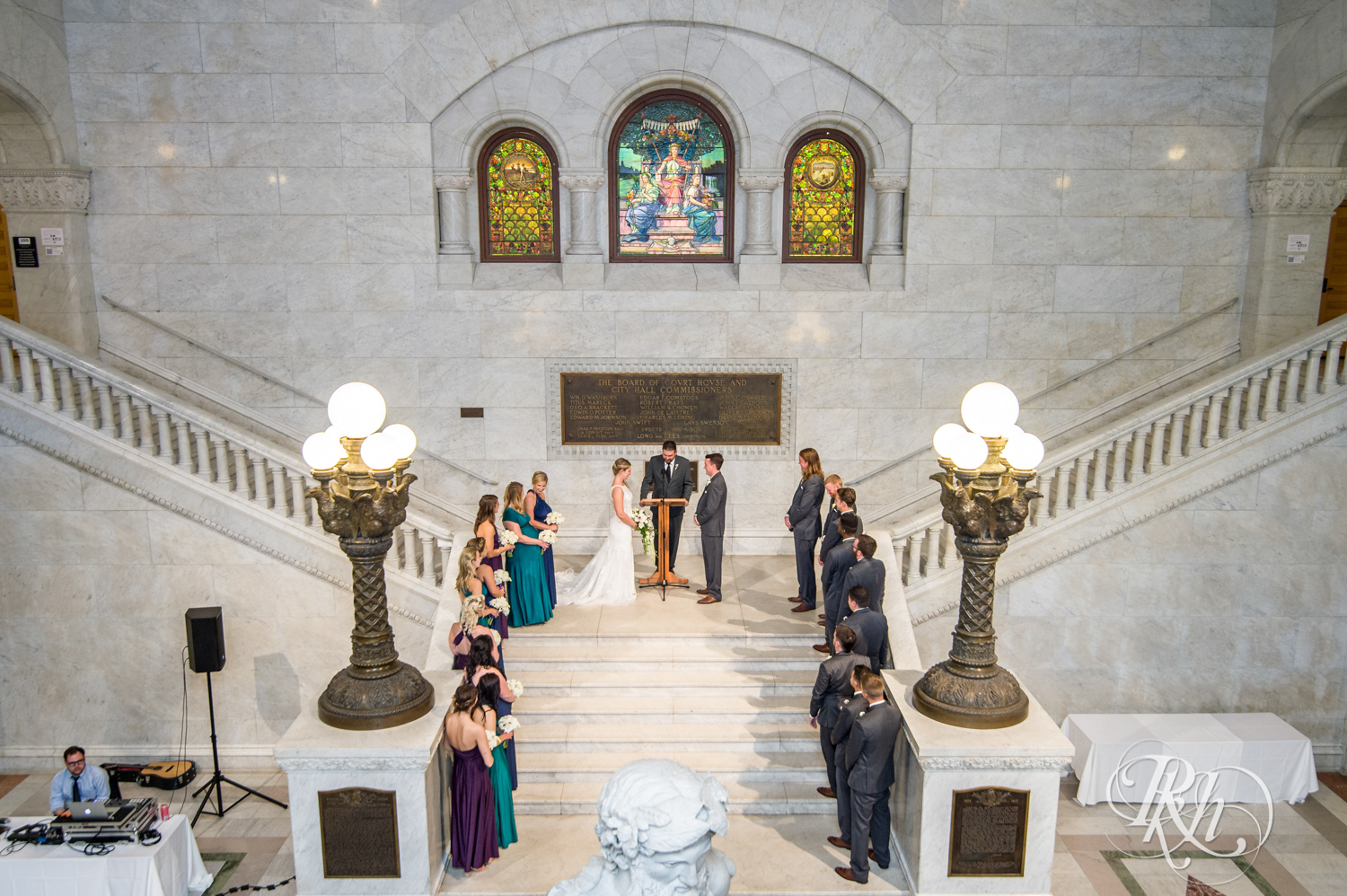 Bride and groom have ceremony on stairs at Minneapolis City Hall in Minneapolis, Minnesota.