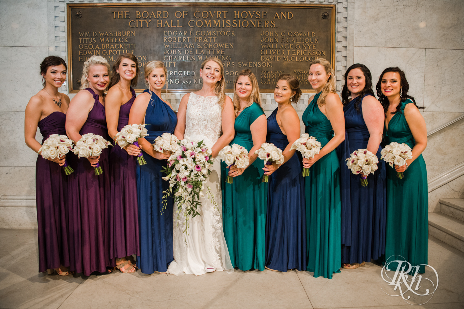 Wedding party in different color dresses at Minneapolis City Hall in Minneapolis, Minnesota.