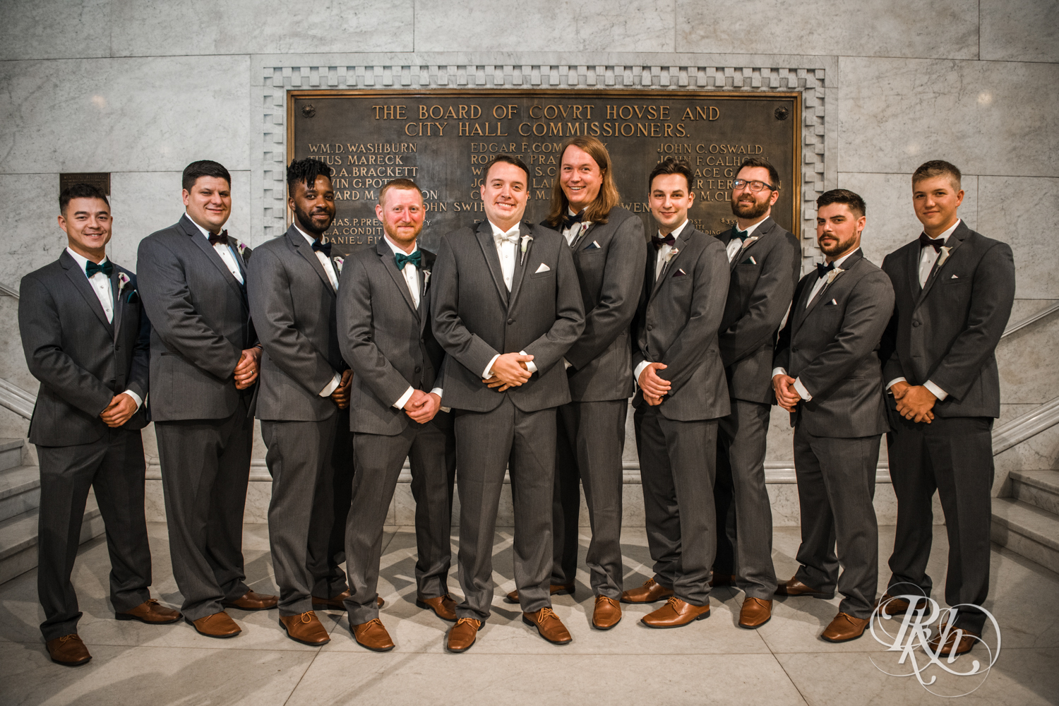 Wedding party in grey suits at Minneapolis City Hall in Minneapolis, Minnesota.