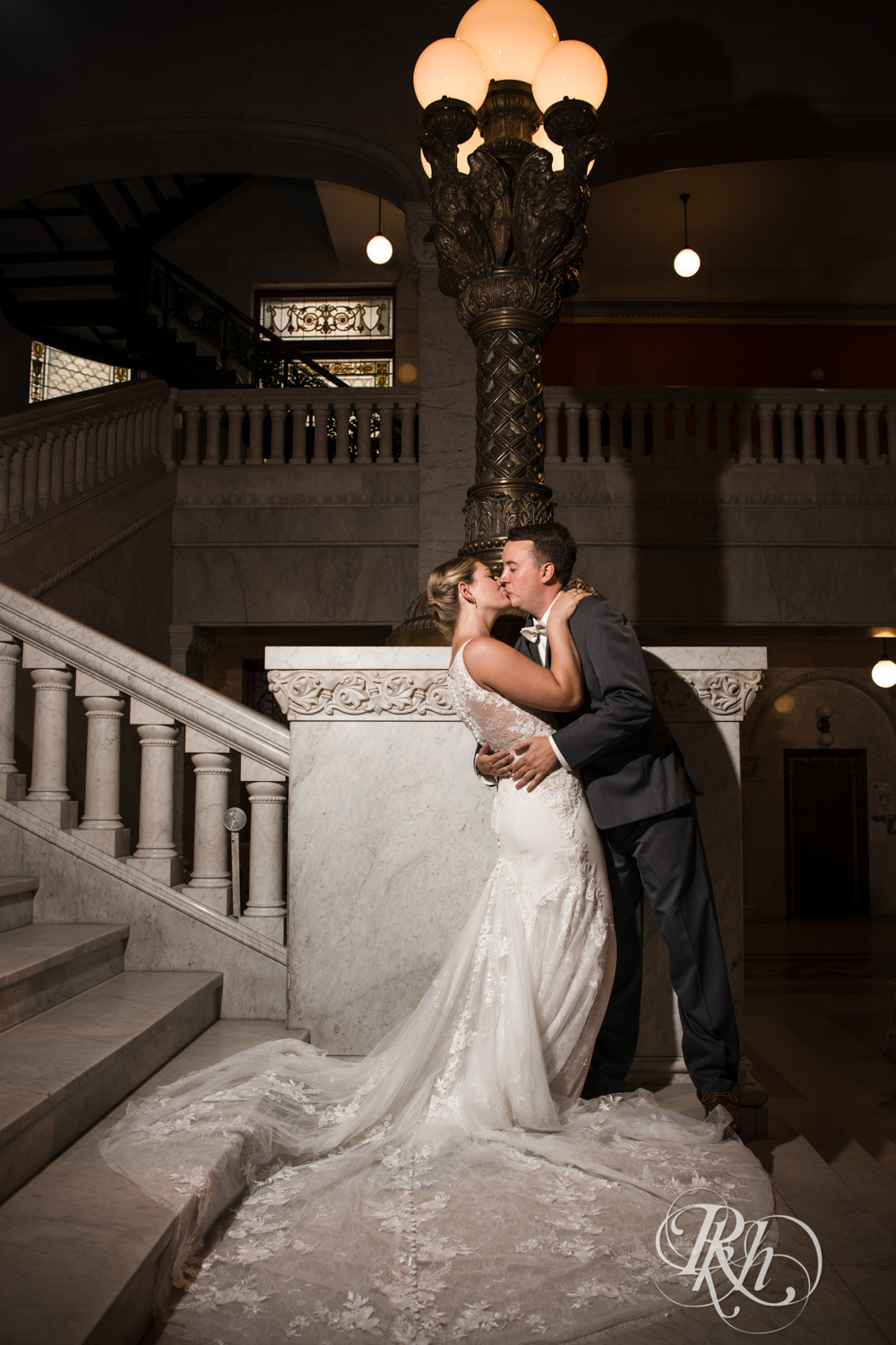 Bride and groom kiss in Minneapolis City Hall in Minneapolis, Minnesota.