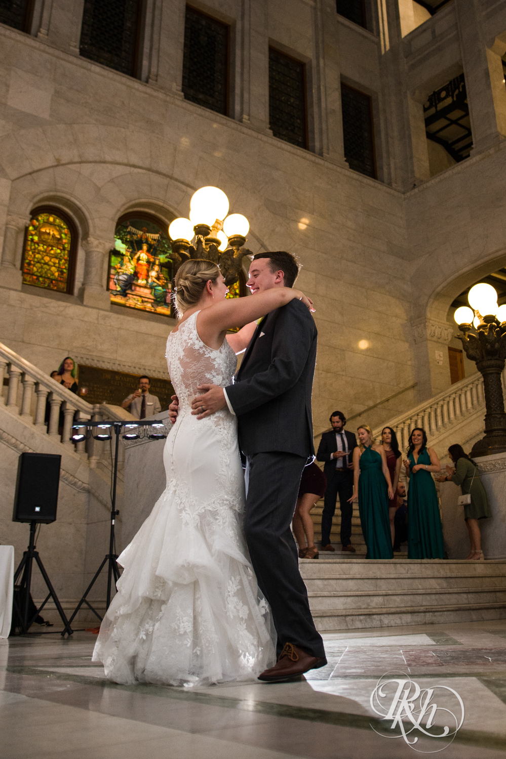 Bride and groom dance at wedding reception in Minneapolis City Hall in Minneapolis, Minnesota.