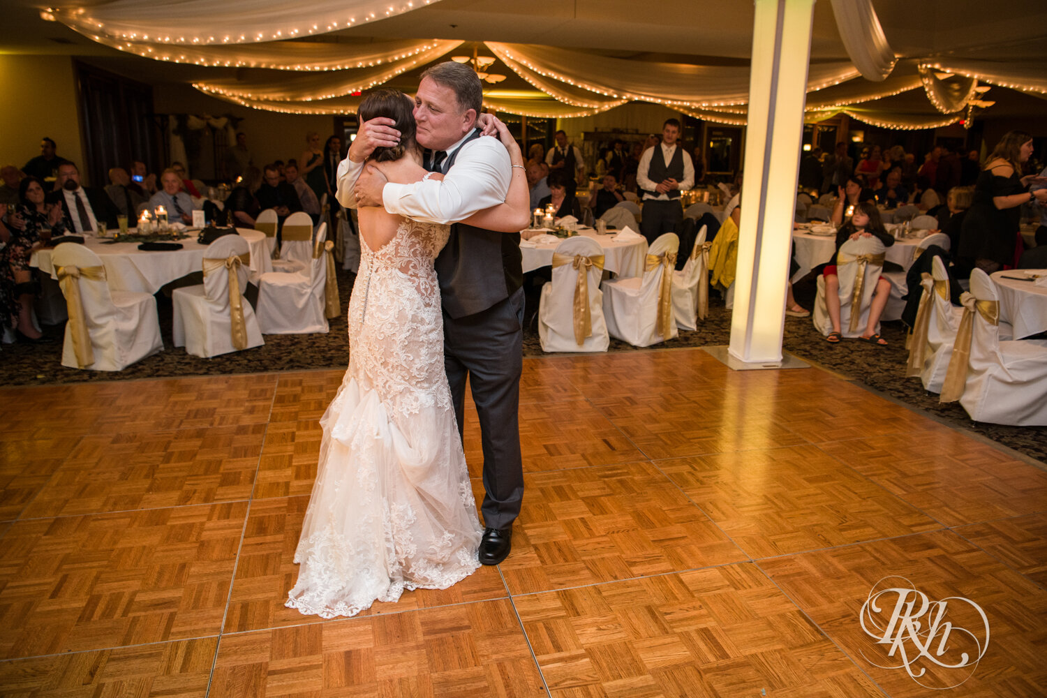 Bride and dad dance at wedding reception on rainy day at The Wilds Golf Club in Prior Lake, Minnesota.