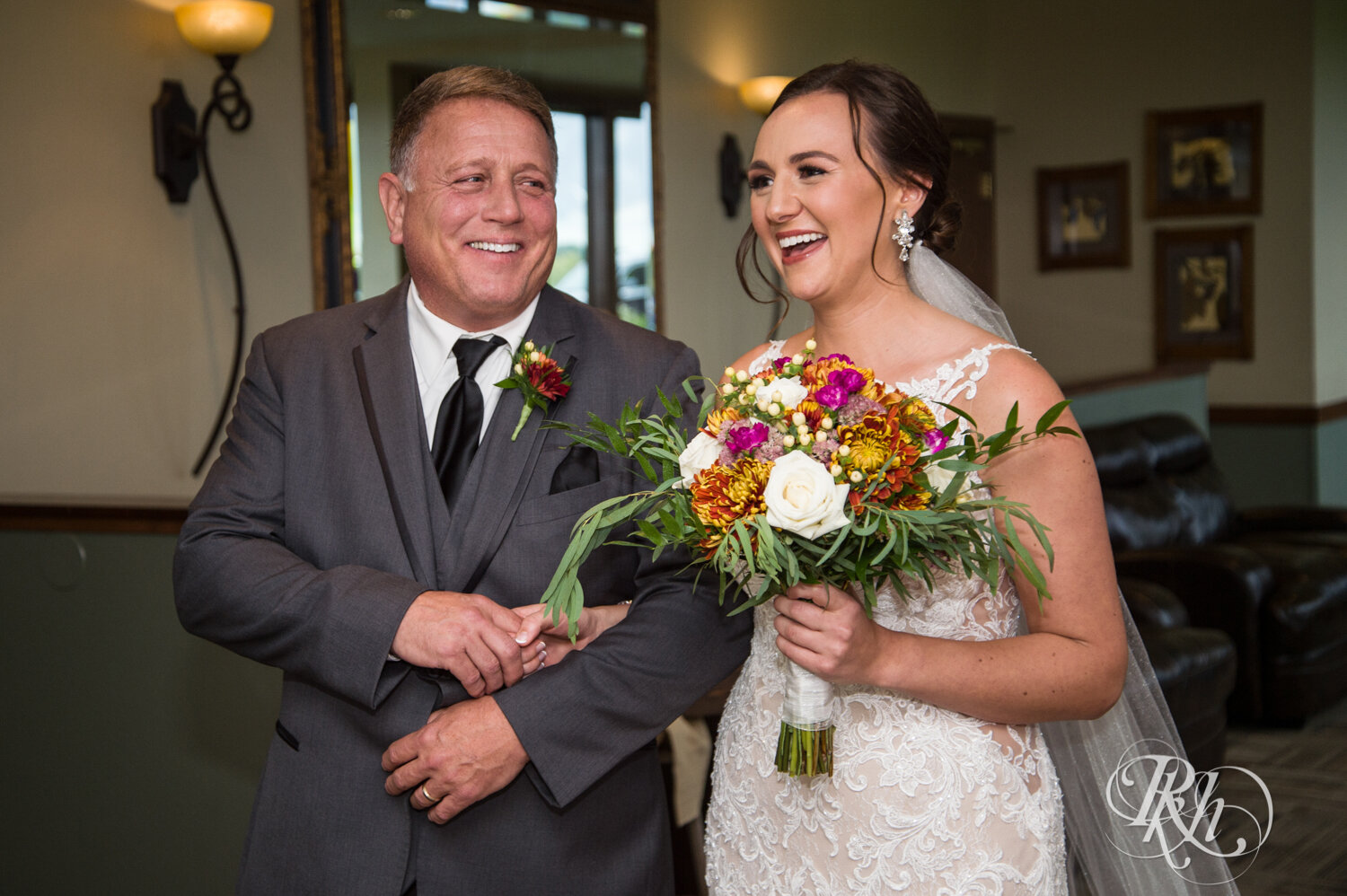 Bride and father laugh together before wedding at The Wilds Golf Club in Prior Lake, Minnesota.