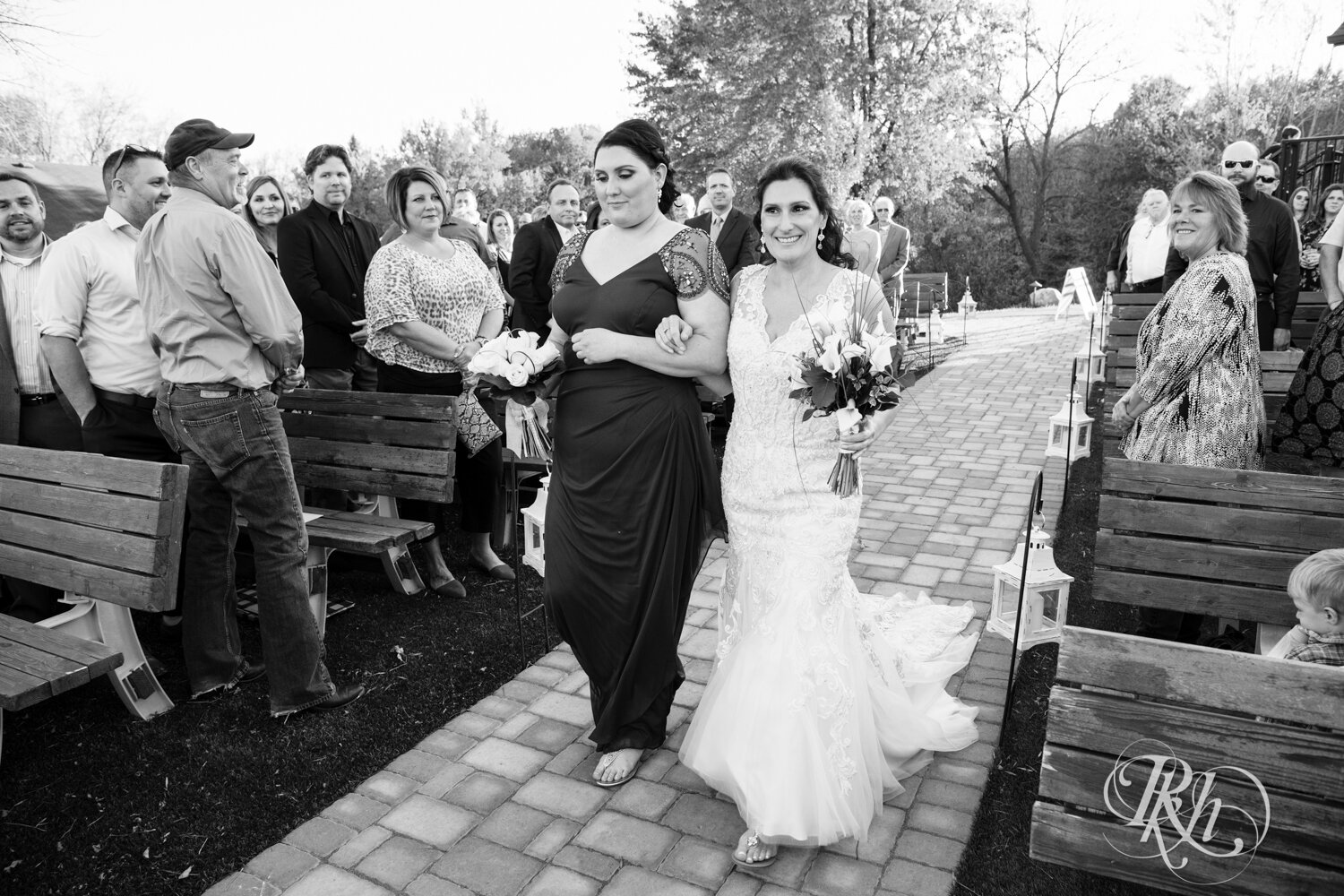 Bride walking down the aisle at wedding ceremony at Minnesota Horse and Hunt Club in Prior Lake, Minnesota.