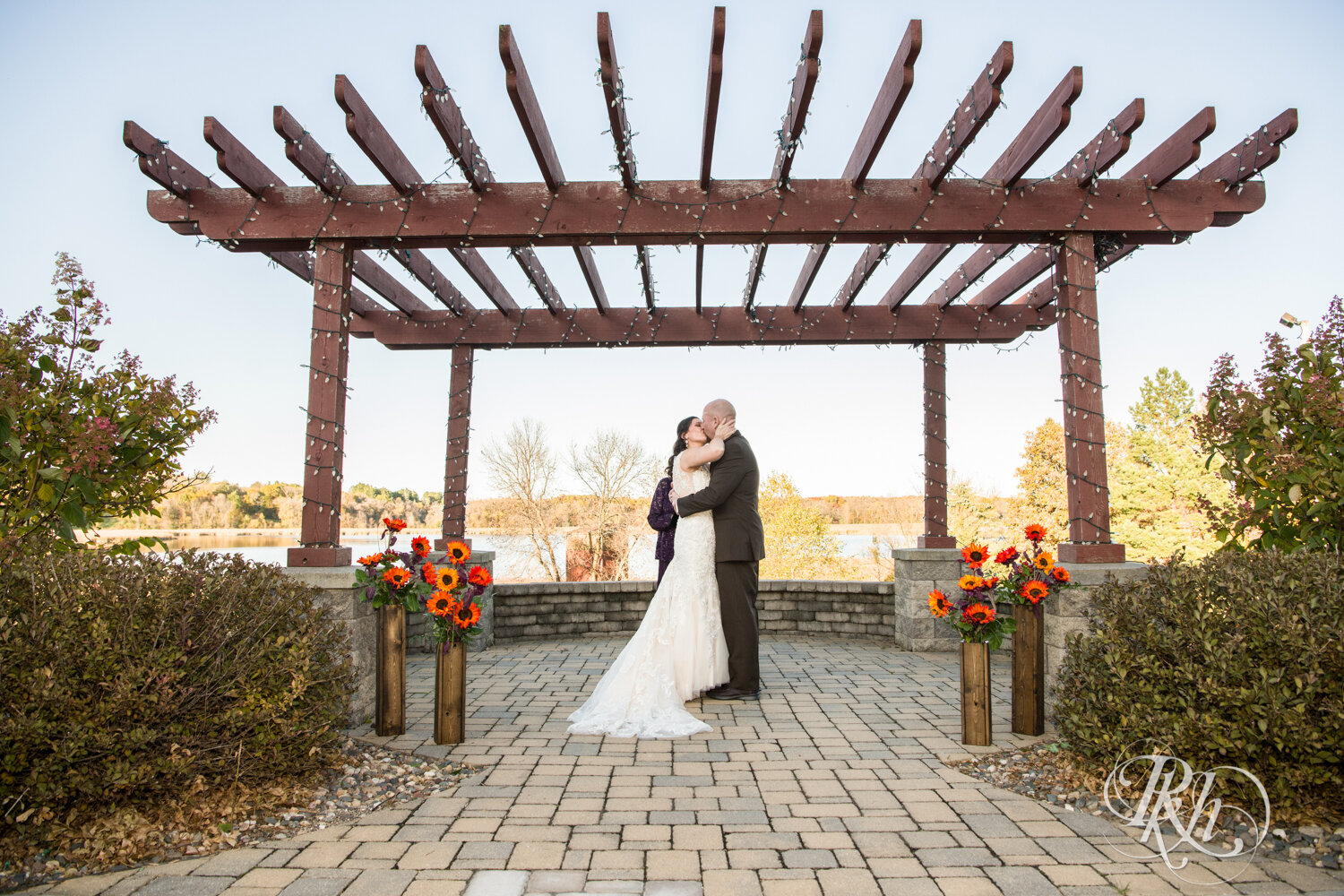 Bride and groom kiss at wedding ceremony at Minnesota Horse and Hunt Club in Prior Lake, Minnesota.